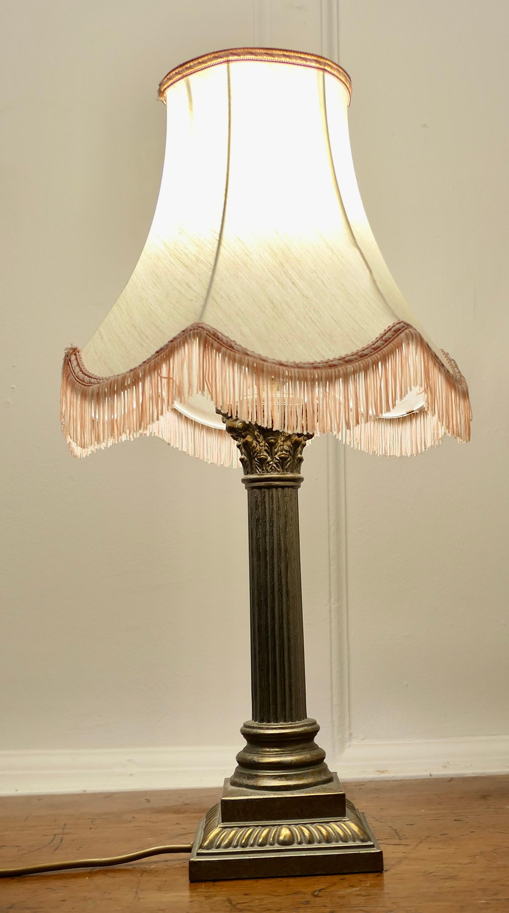 A Copper Effect Corinthian Column Table Lamp with Shade

This is a very attractive lamp it has a heavy single corinthian style column which is made in brass and finished to look like Sheffield plate with copper highlights, it is set on a stepped