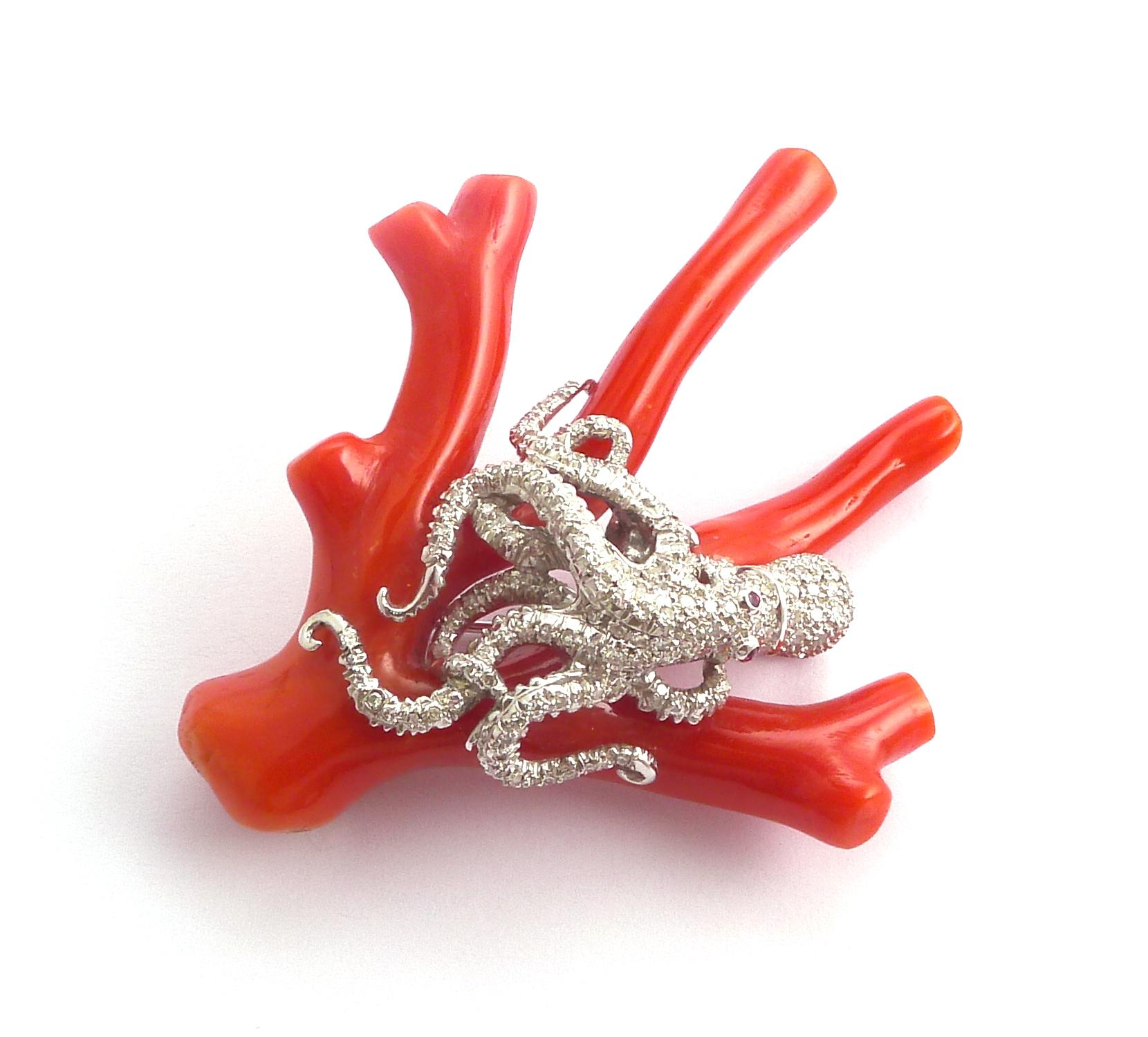 The pavé-set diamond octopus with ruby eyes, on a carved red coral branch

Mounted in platinum
