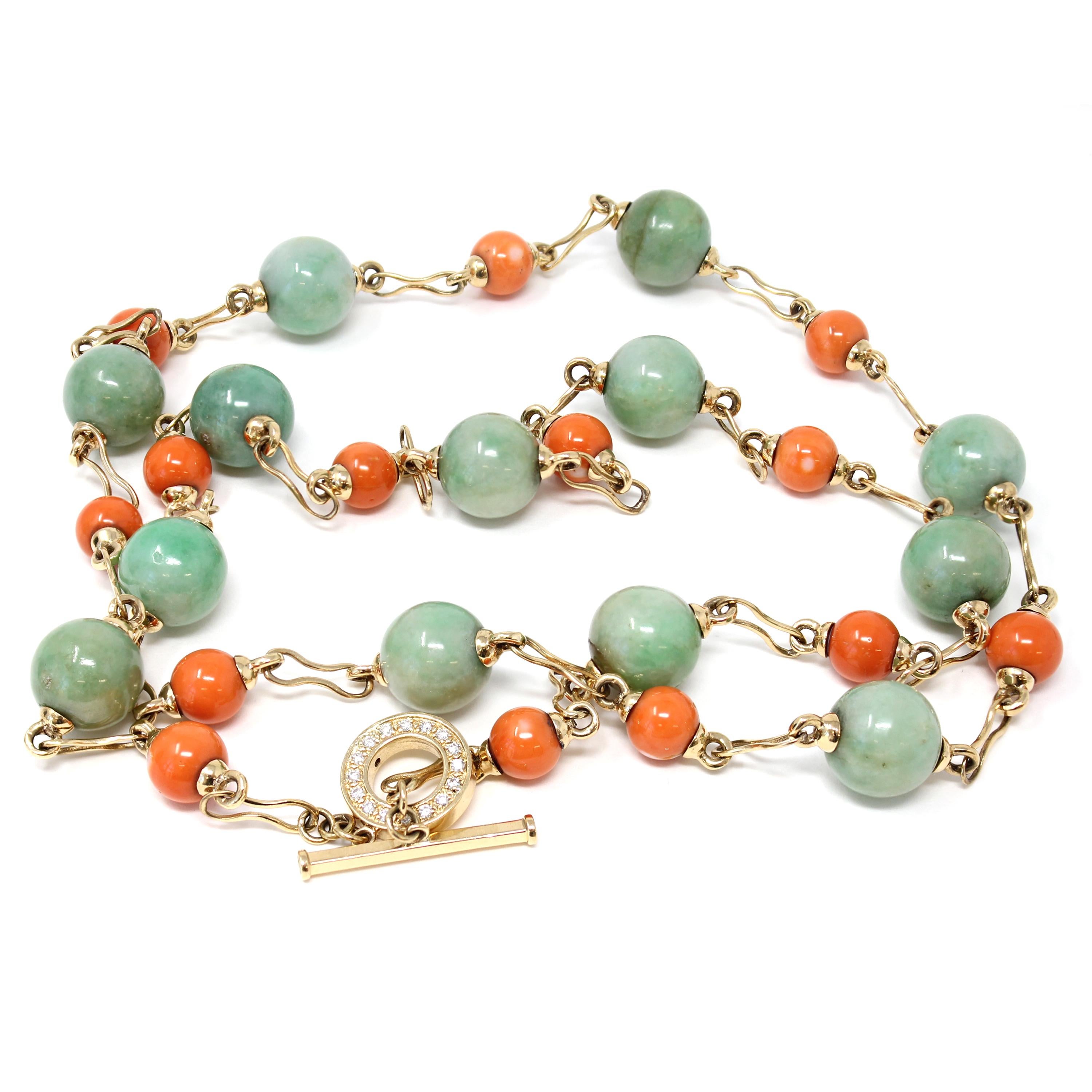 This One of a kind necklace by Rosaria Varra features natural vintage Jadeite jade apple green beads alternating with natural salmon color coral made into a station style necklace set in 18 yellow gold. The apple green jade beads measure 14.3mm
