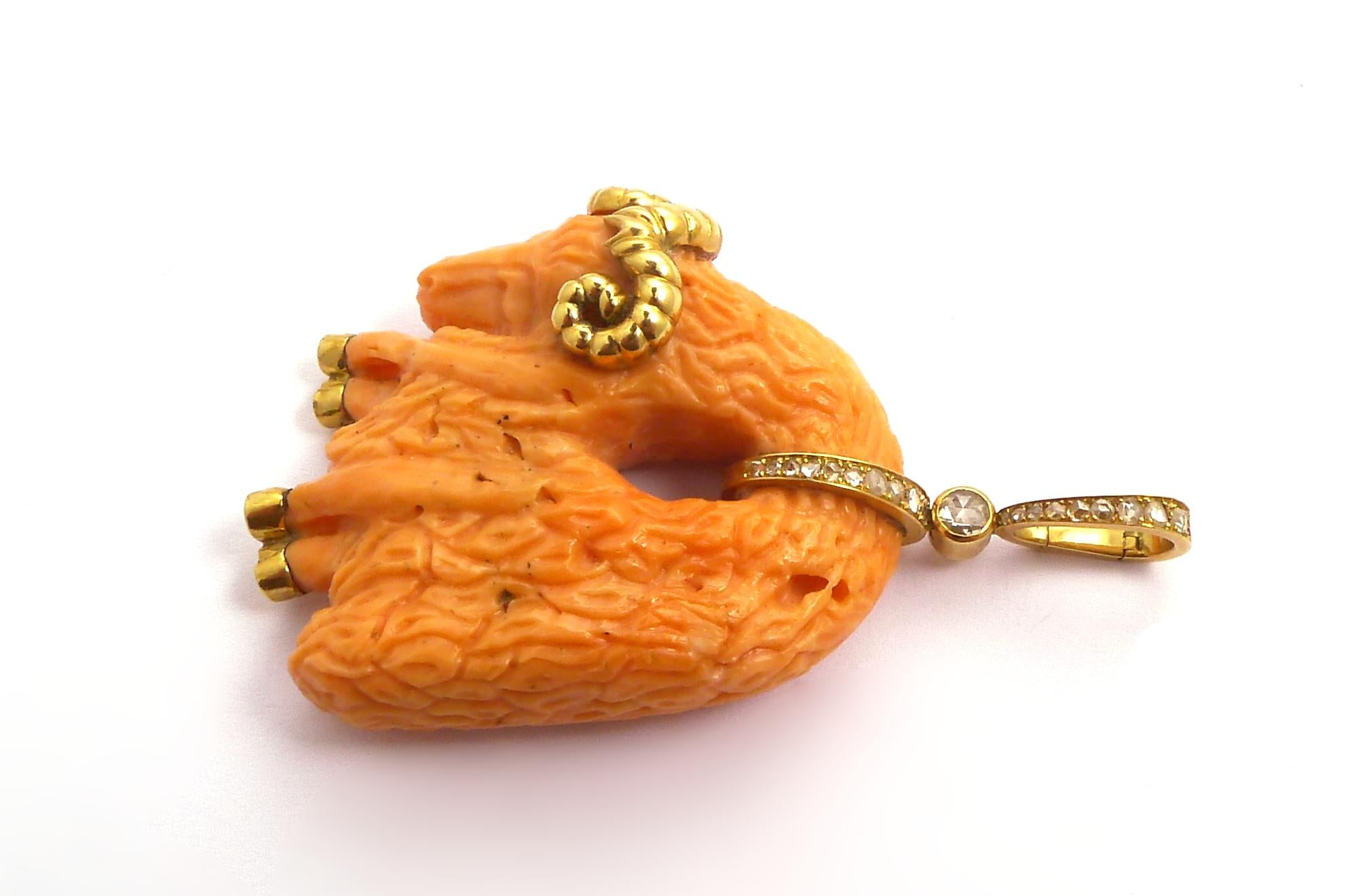 The carved coral hanging ram enhanced with gold detail and rose-cut diamond suspension hoop

Mounted in 18K yellow gold