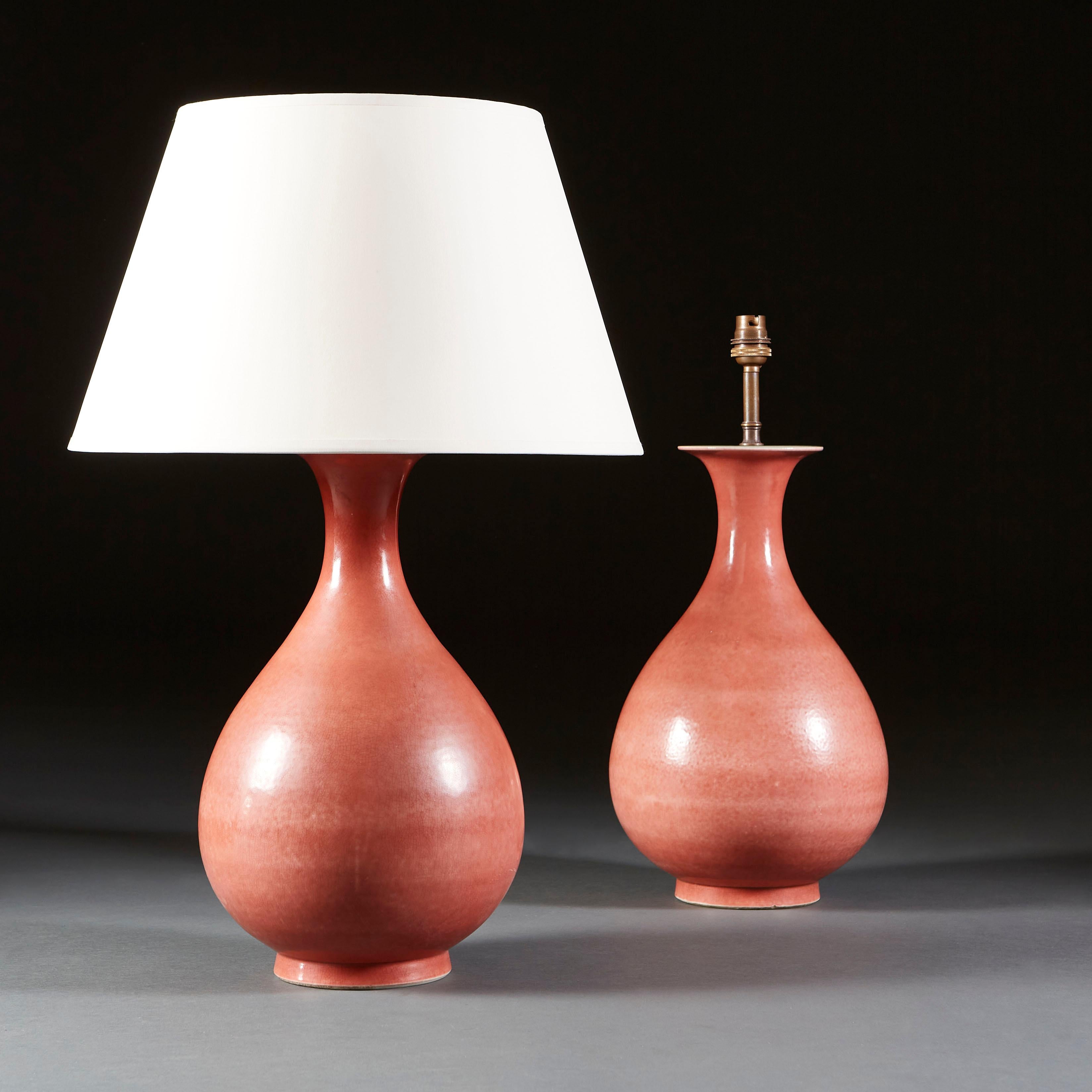 A French studio pottery vase of bulbous form terminating in a flared neck, with irregular application of the coral glaze resulting in gentle undulations of pink tones across the surface of the vessel, now as a lamp.

Currently wired for the UK.