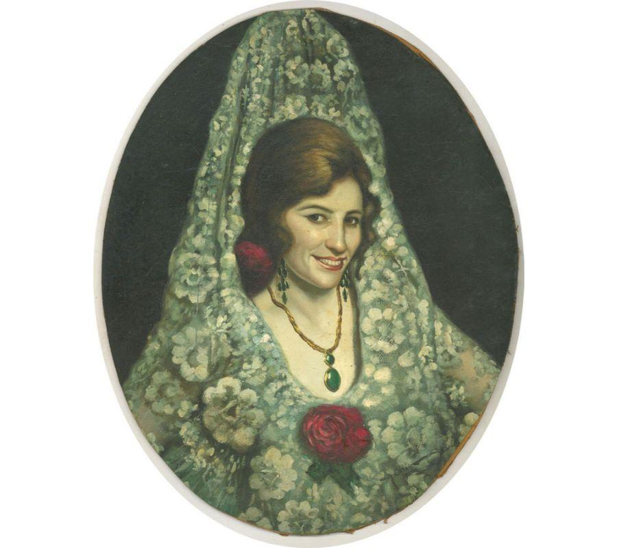 A very fine portrait of a smiling Spanish lady dressed in fine lace, with fresh red flowers in her hair. She wears large green jewels around her neck and ears. The artist has wonderfully captured the sitter with a uniquely animated face. Signed and