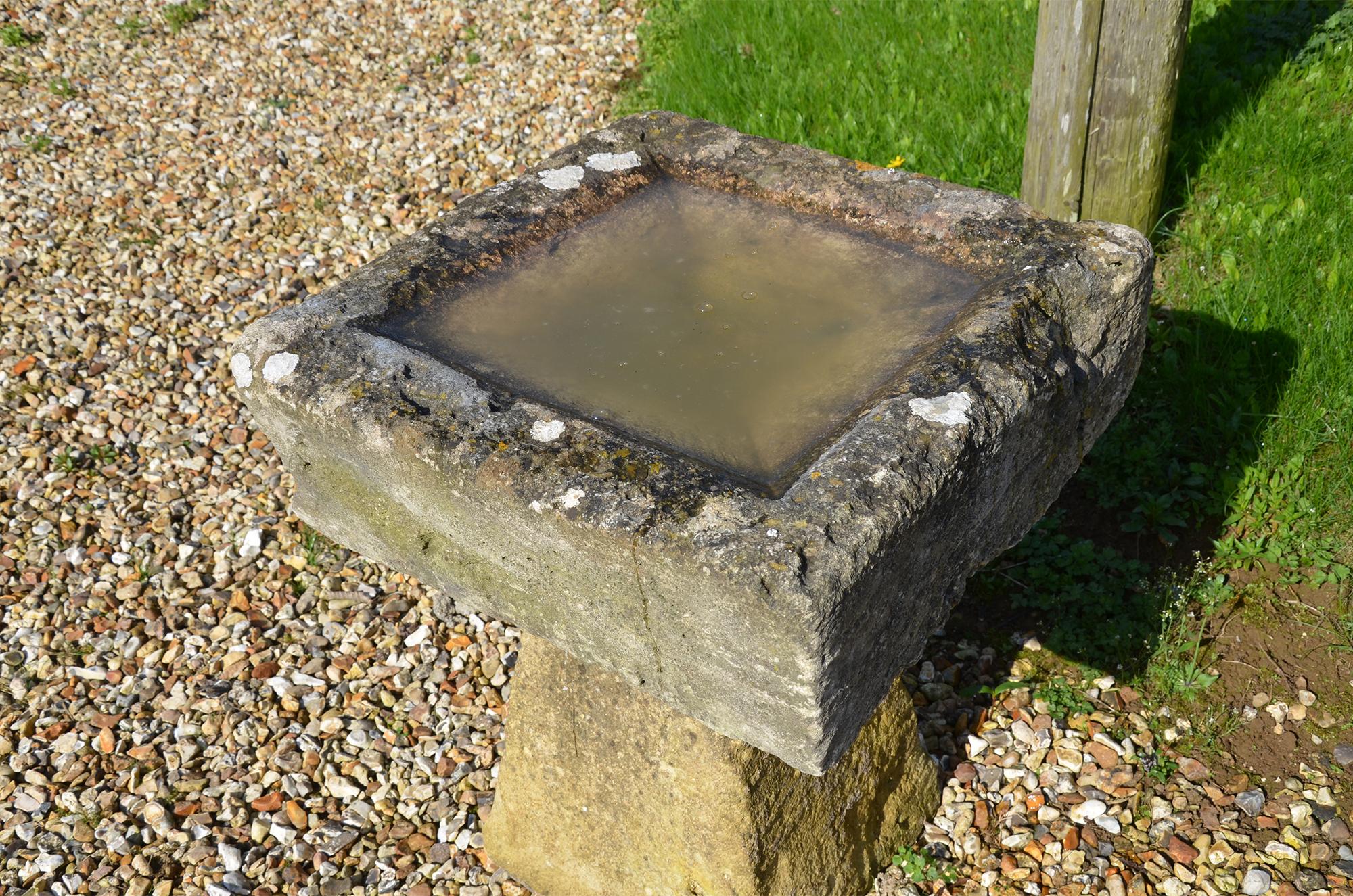 Raised on an old staddlestone plinth, this is a birdbath made up from an old Cotswold stone element, in its previous life it was a drain!