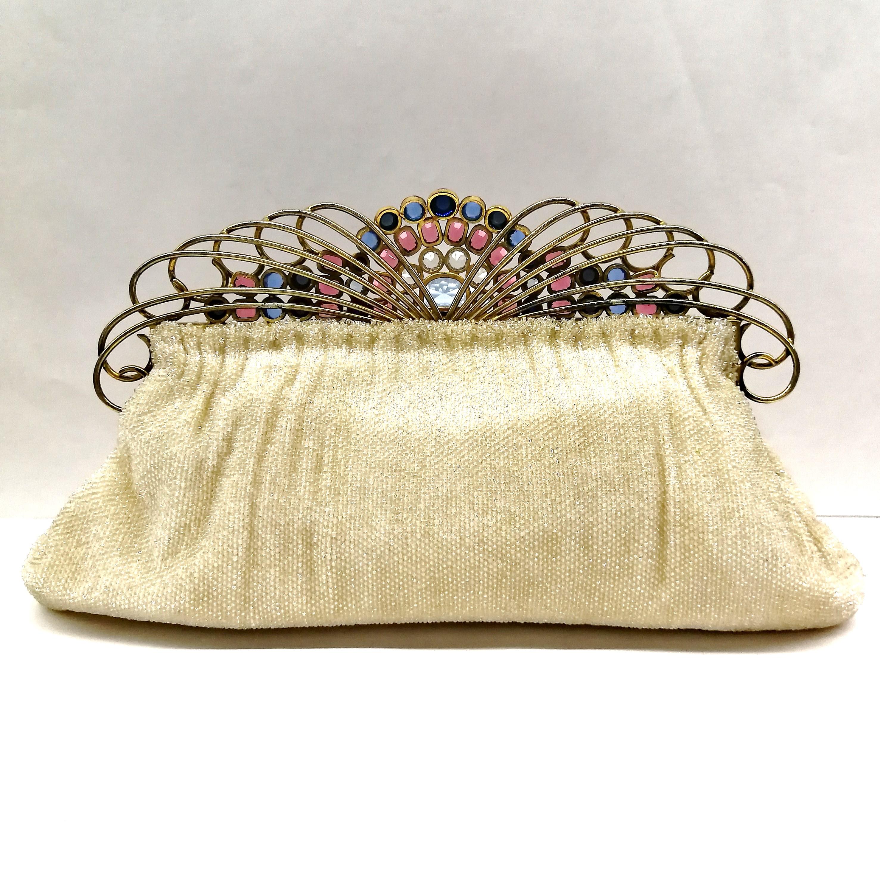 This rare and iconic clutch bag, in the realm of vintage and collectable handbags, made for Saks Fifth Avenue by Josef, is crowned with an exuberant and baroque frame/clasp, made by the celebrated jewellery manufacturer Hobe, set with sapphire glass