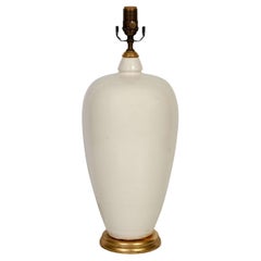 A Cream Color Ceramic Lamp on Giltwood Base with Linen Shade