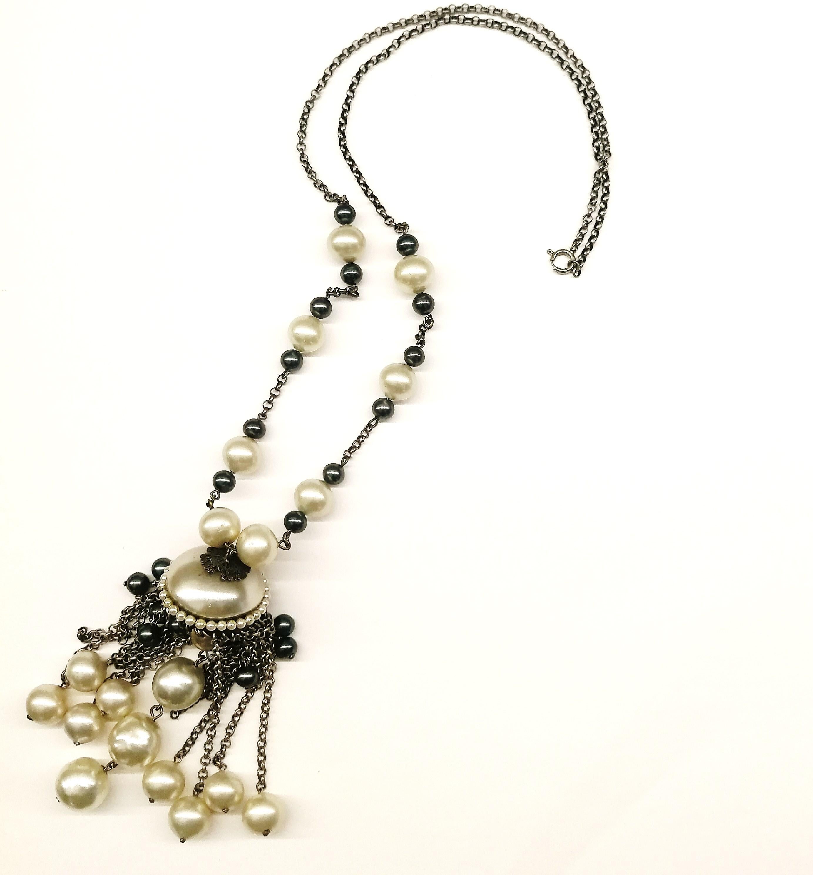 A large and striking sautoir necklace, with a full and graduated pendant, with baroque pearls of assorted sizes, in steel grey and cream, with darkened chain. It is attributed to Louis Rousselet from Paris, by the quality and colour way of its