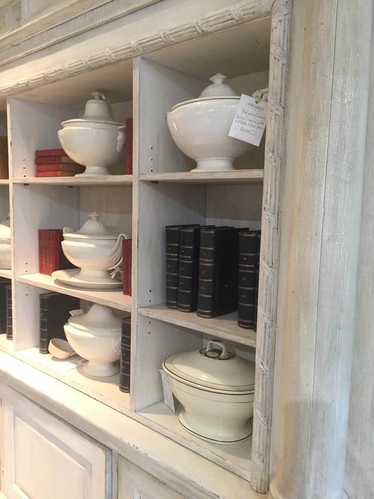 A cream painted wooden neoclassical bookcase in two sections at 1stDibs