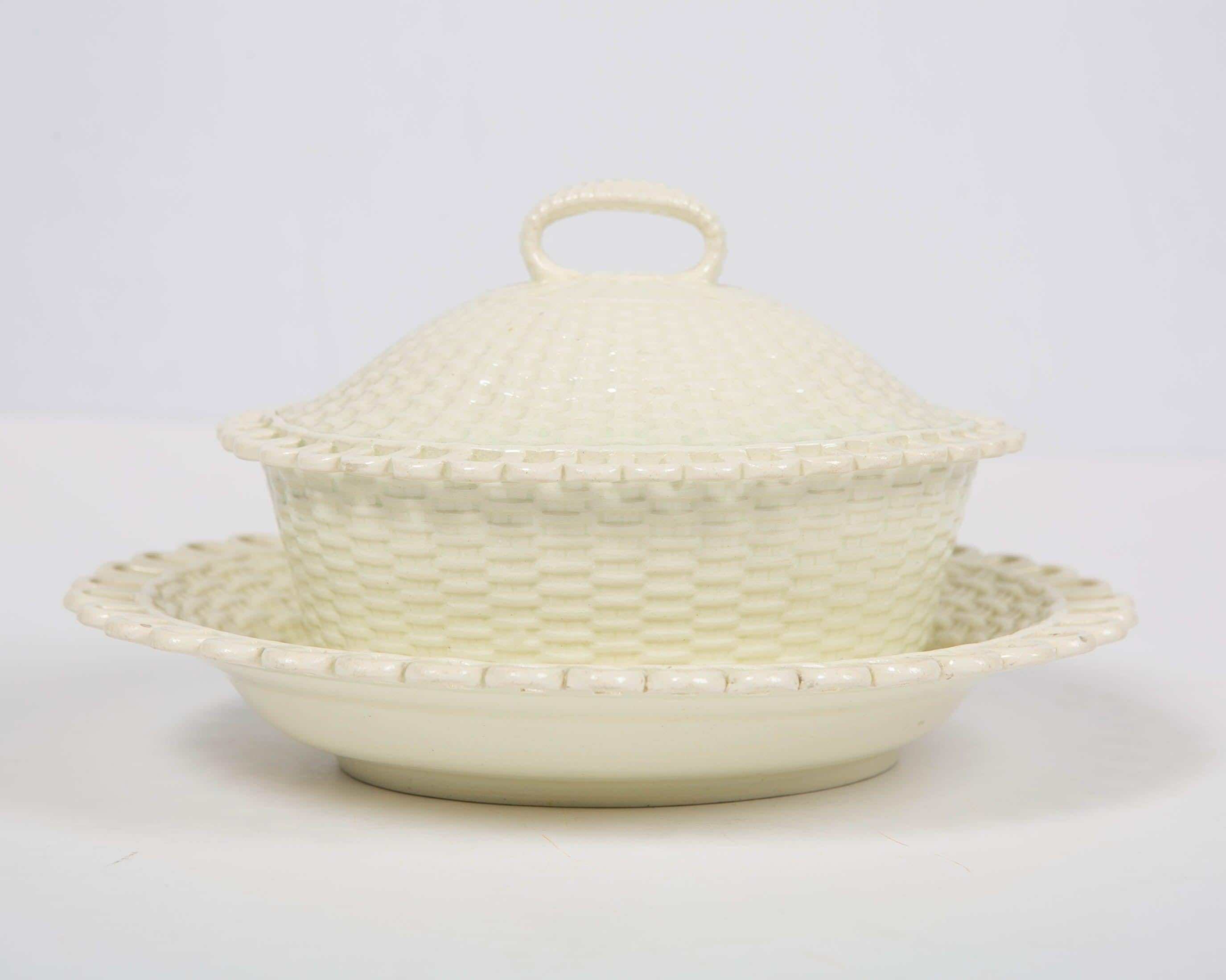Why we love it: The creamy color and the pure beauty of the decoration
We are pleased to offer this 18th century English creamware sauce tureen and stand decorated with an impressed basketweave pattern and lovely weave of delicate