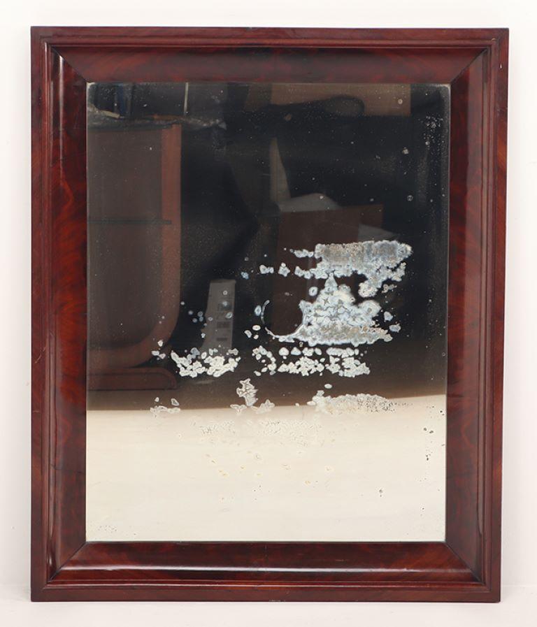 French A crotch mahogany Empire wall mirror circa 1830. For Sale