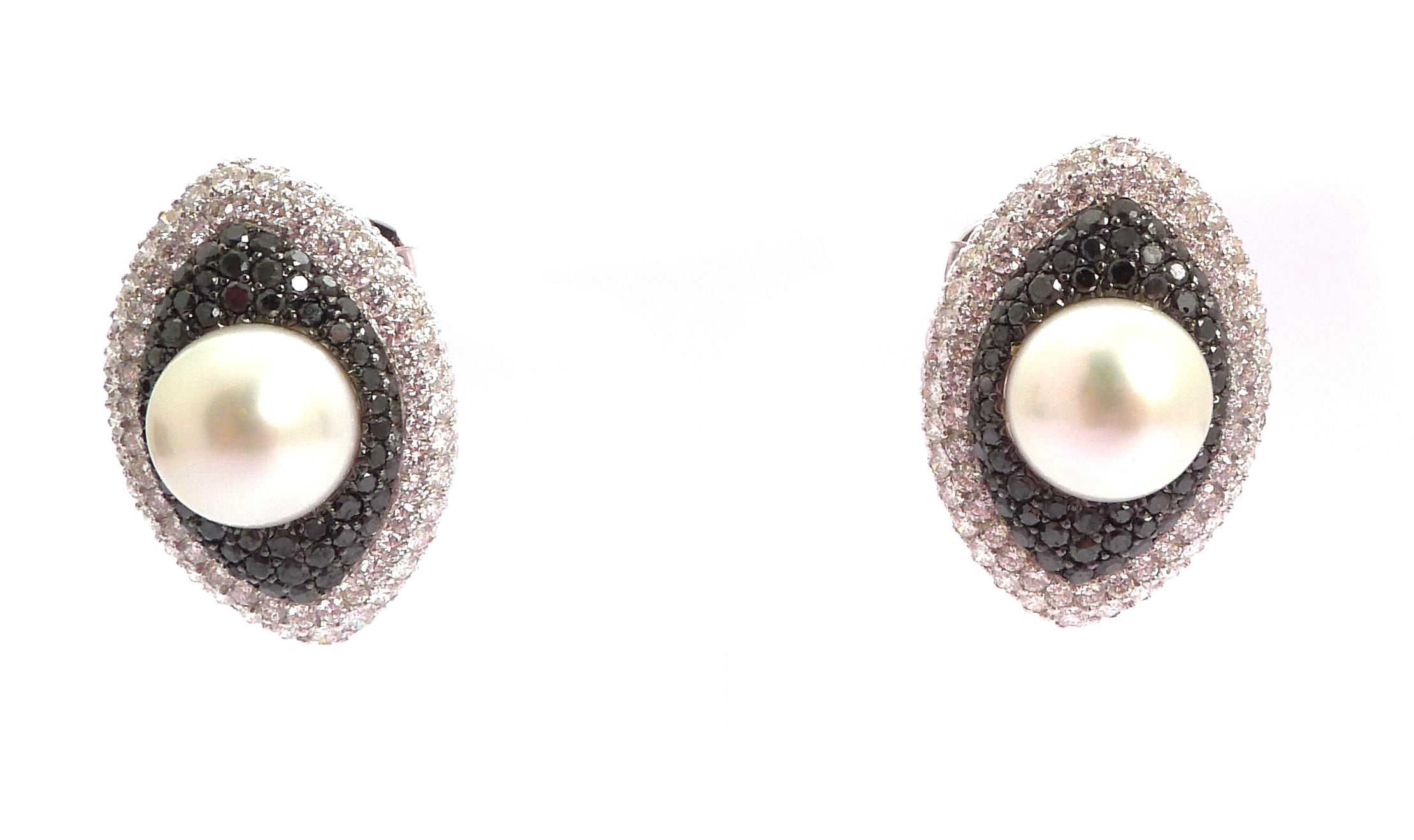 Each centering upon a white cultured pearl in a tiered 'navette' surround pavé-set with diamonds and black diamonds

Mounted in 18K white gold

- 2 cultured pearls: 55.84 ct total, white
- 128 black round diamonds: 4.88 ct total
- 280 round