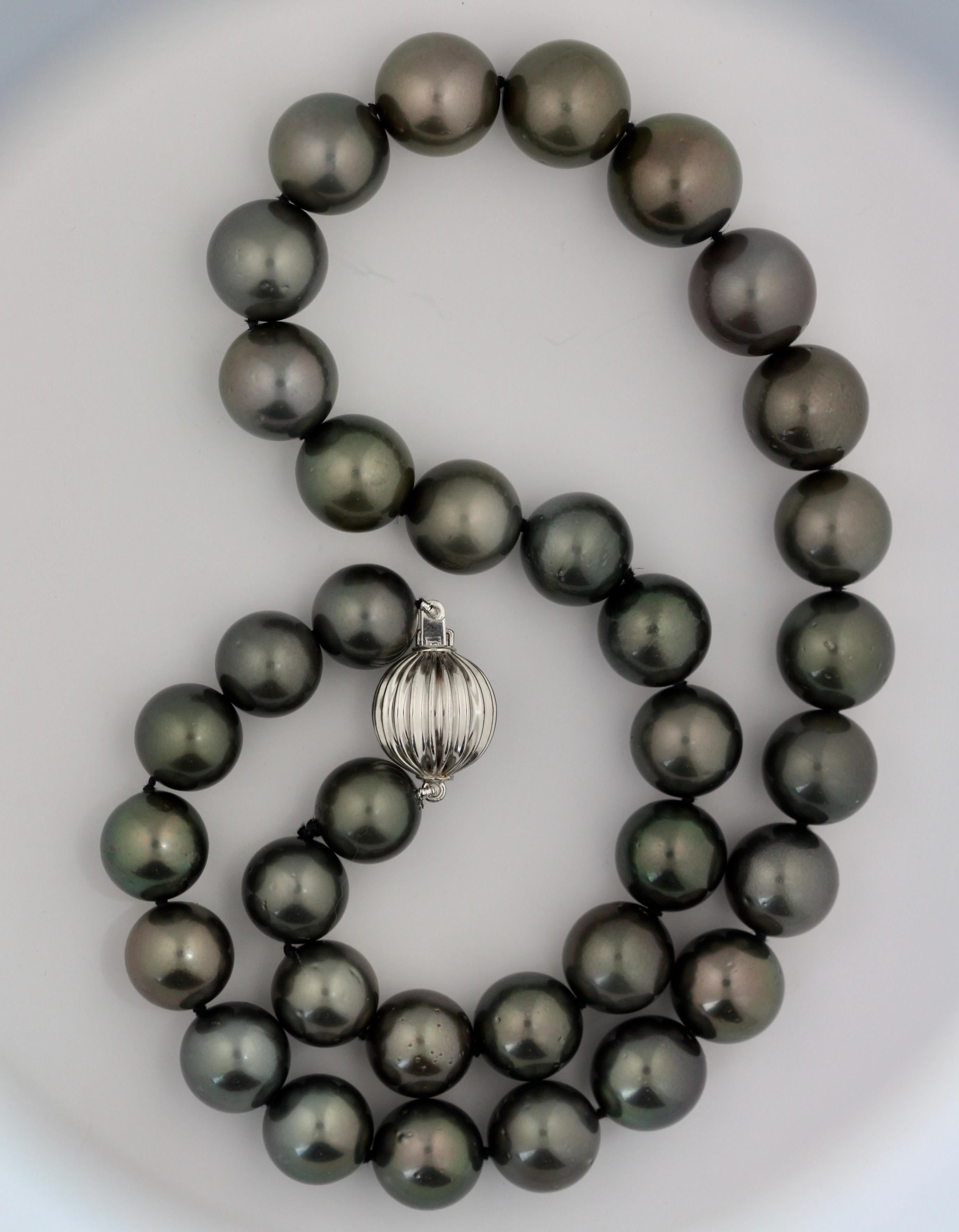 A CULTURED PEARL NECKLACE
the single strand composed of thirty-five Tahitian pearls measuring approximately 11mm to 14mm in diameter, completed by a 14 carat white gold ball clasp