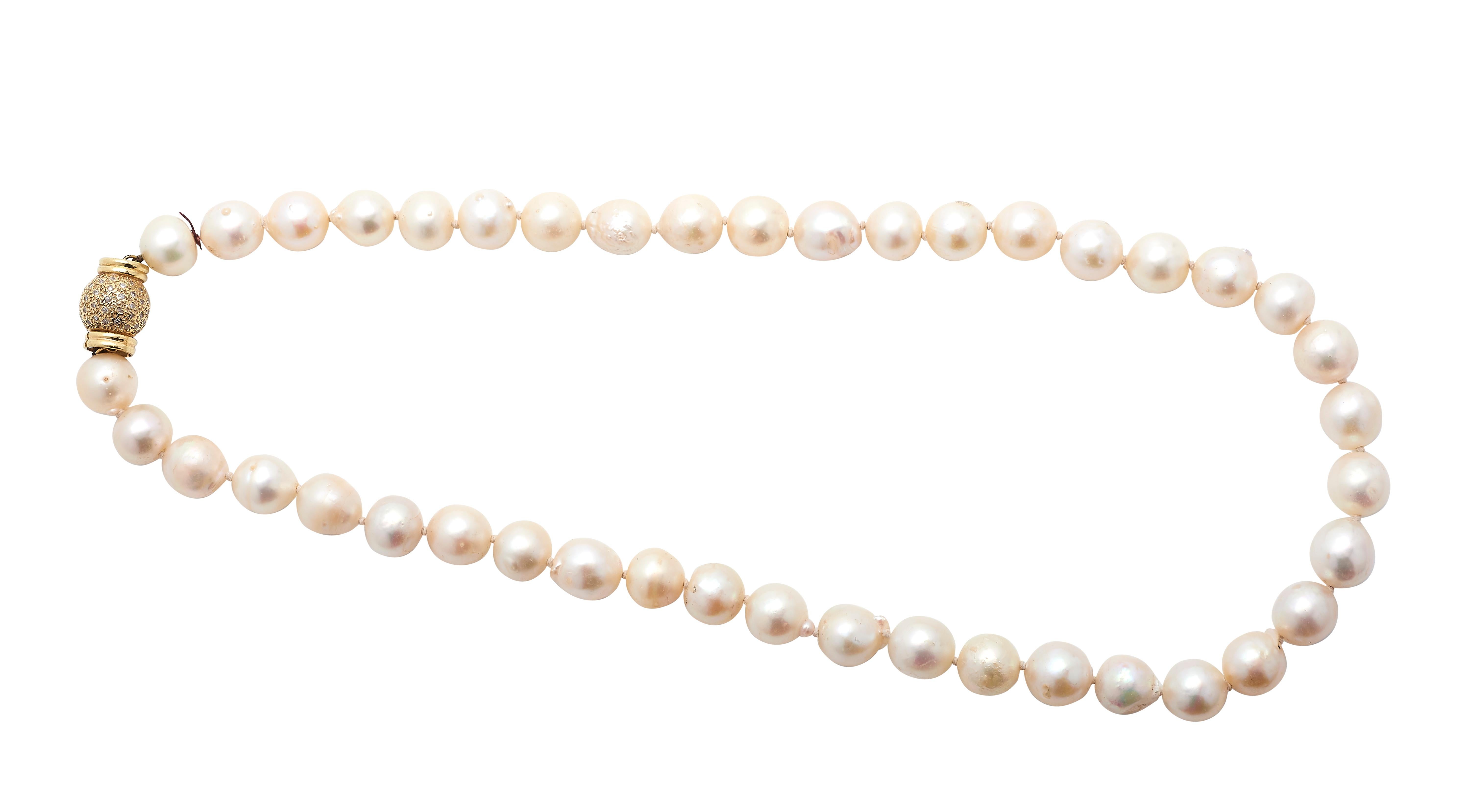 A Cultured Pearl Necklace
the single graduated strand composed of forty-two pearls
measuring approximately 10mm to 11mm in diameter,
completed by an 14 karat gold and diamond clasp
Length 19 in. (48.26 cm.)
65.7 grams (gross)