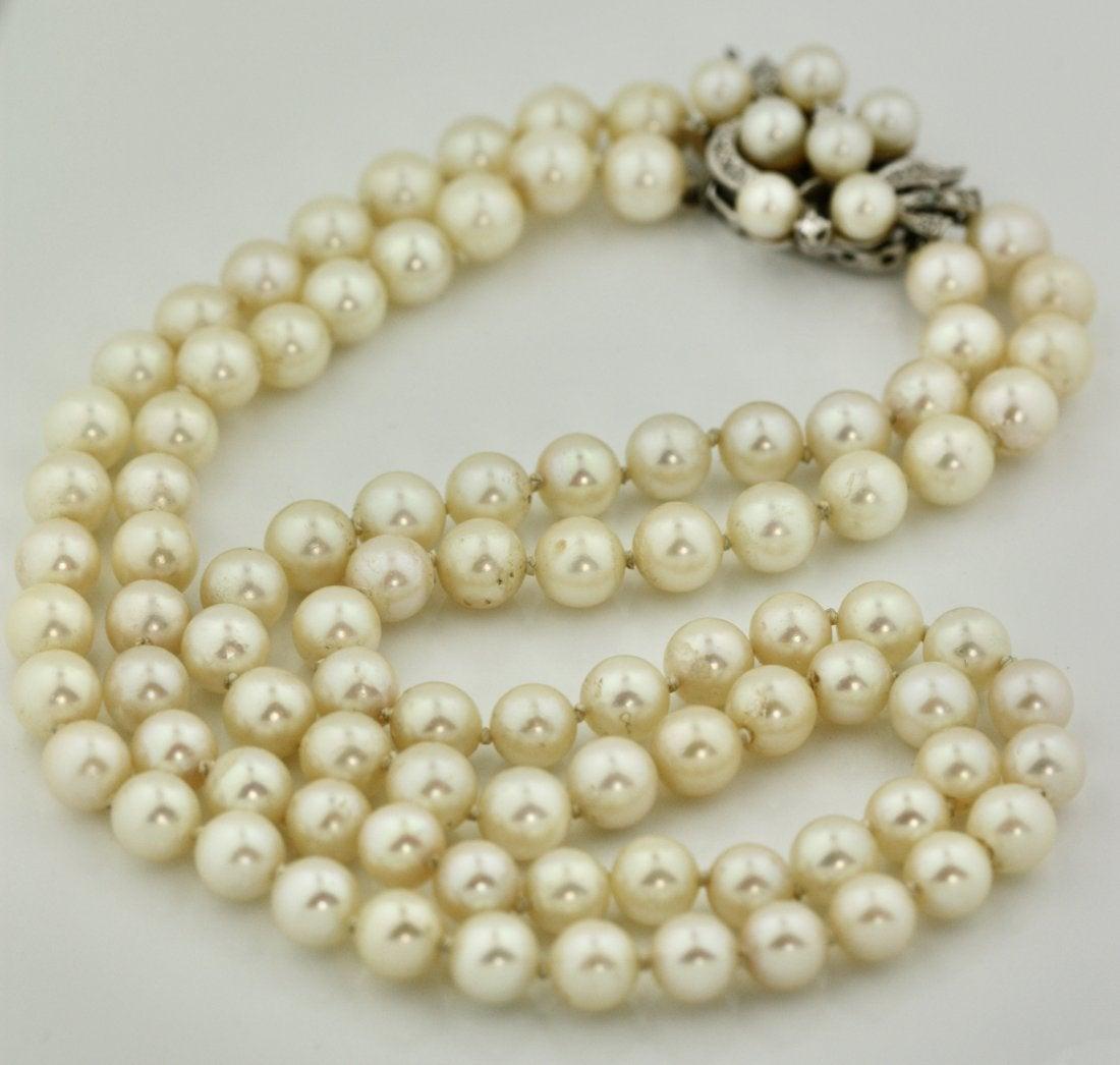 A Cultured Pearl Necklace the double graduated strand composed of seventy-seven pearls measuring approximately 5 mm to 7 mm in diameter, completed by a white gold clasp.