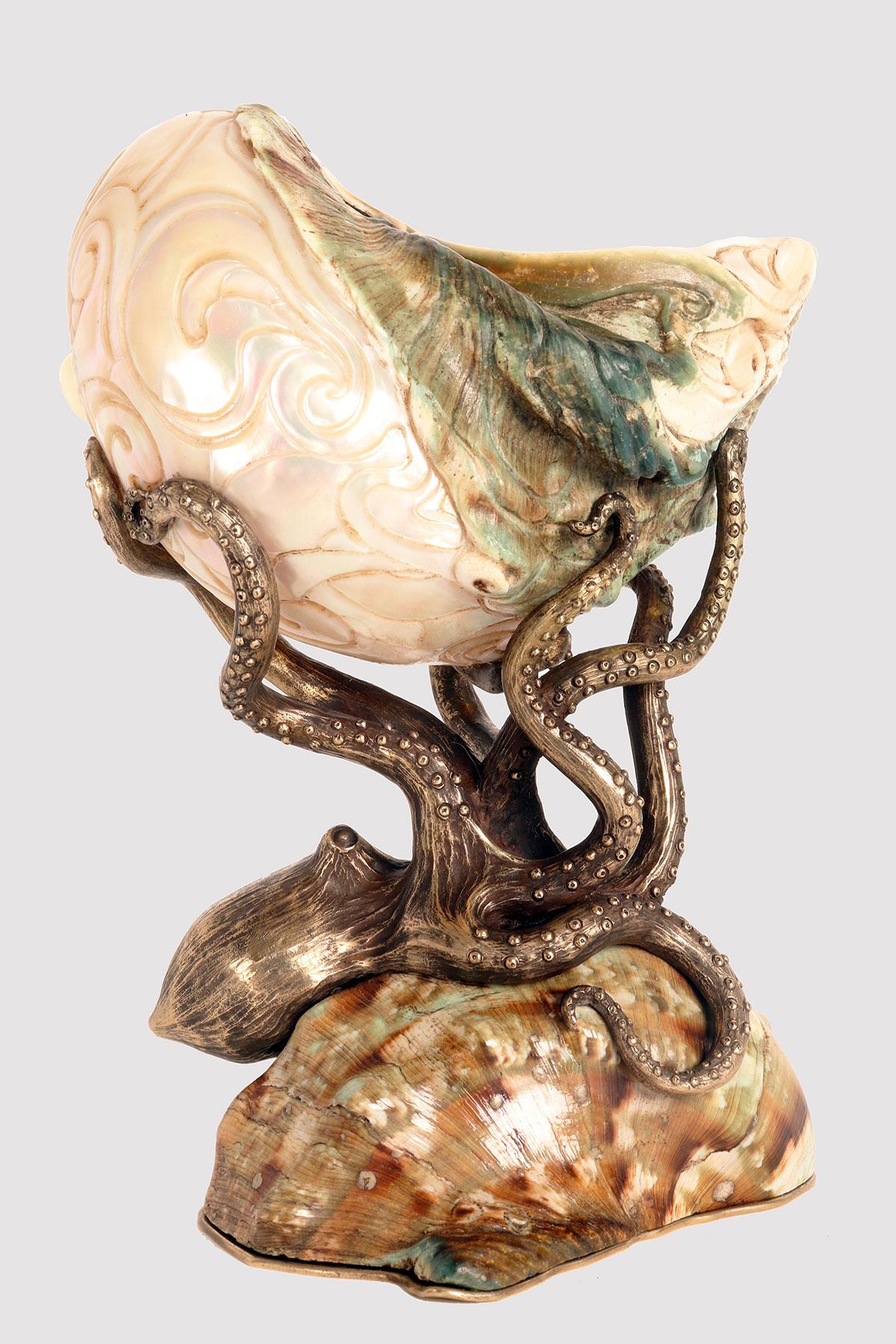 A Specimen Naturale from Wuderkammer: a cup with a shell of Turbo marmoratus, knowns as the green turban, the marbled turban or great green turban. The Specimen is mounted on a gilt bronze structure depicting an octopus and features engravings