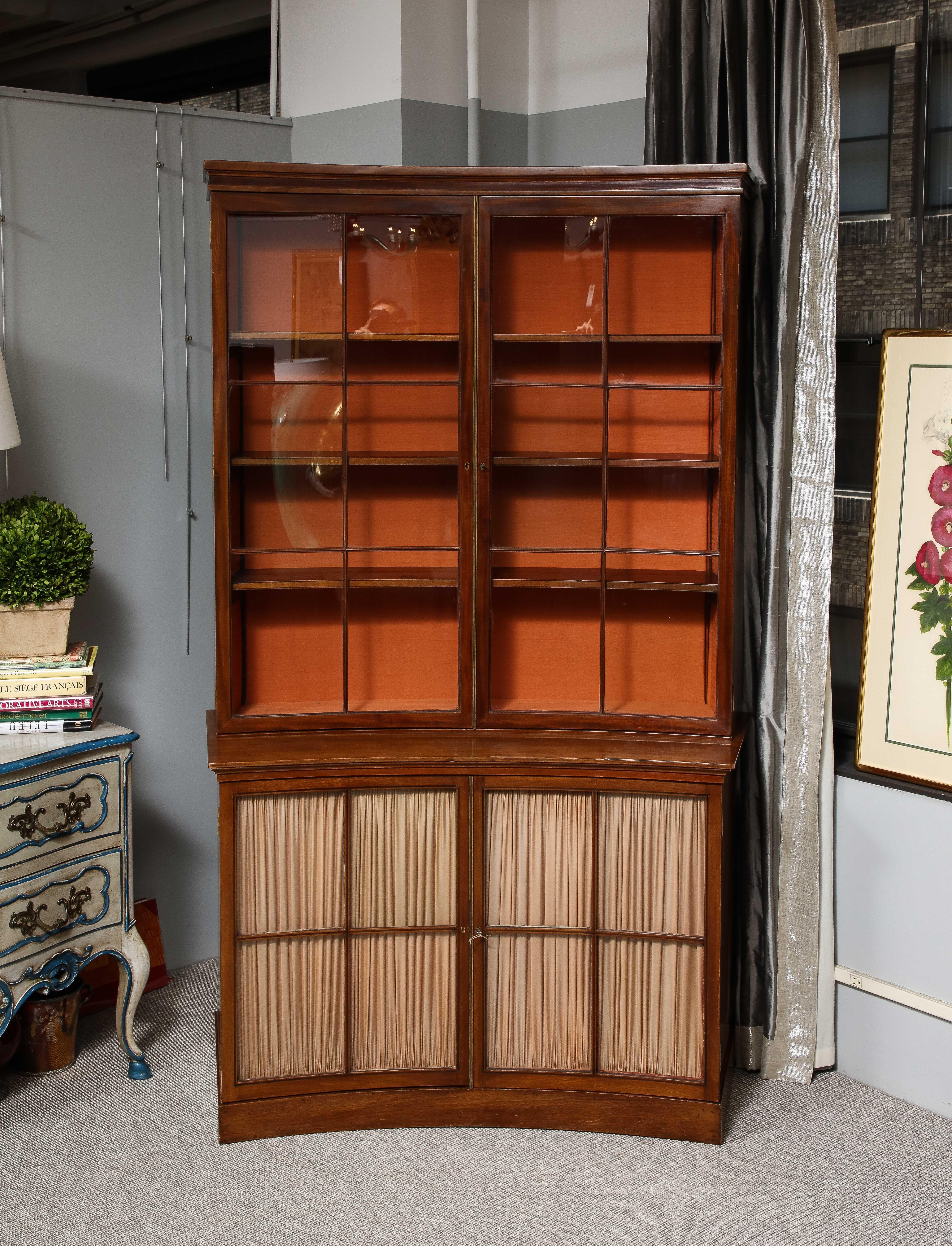 A spectacular 19th-century mahogany vitrine cabinet that could be the star attraction in any room.  The slightly curved cabinet is one of a pair in our inventory and come from a private Paris apartment.  They are both in excellent condition.  Each