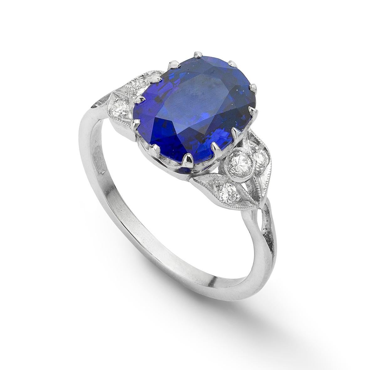 A cushion-shape sapphire and diamond ring, the sapphire weighing 3.66 carats, claw set to a platinum mount with diamond-set leaf shoulders, hallmarked platinum, London 2012, made by Bentley and Skinner,  the head measuring approximately 1x0.8cm,