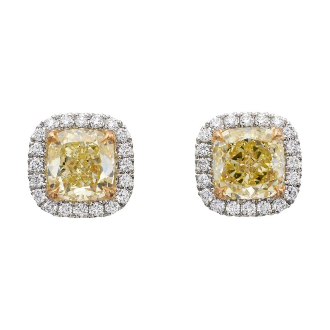A Cushion Shaped 1.31 ct Fancy Yellow Internally Flawless and VS2 Diamond Earrings The Earrings are made with 18 karat White Gold with accompanied side stones 1.28 - 1.29 mm it is a FG - VS 0.34 carat