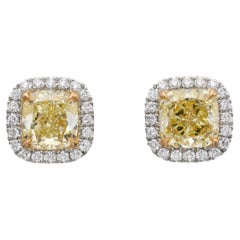 A Cushion Shaped 1.31 ct Fancy Yellow Internally Flawless and VS2 Diamond Earrin