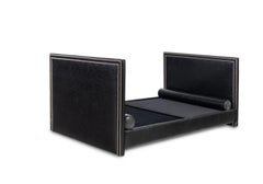 A Custom Faux Leather Daybed together with two matching bolster pillows.