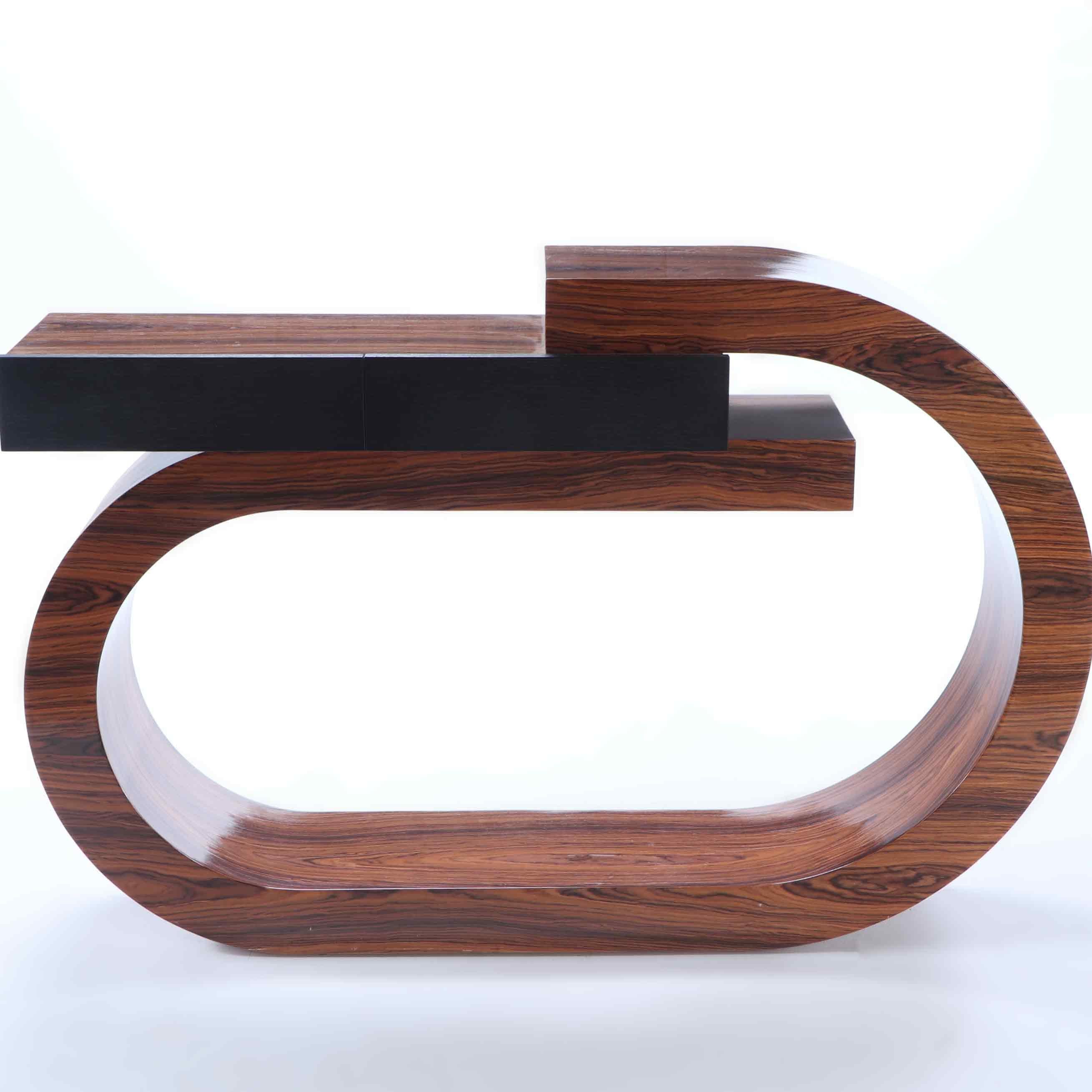 A stunning custom made Art Deco style rosewood console table having an arching design with two ebonized drawers.