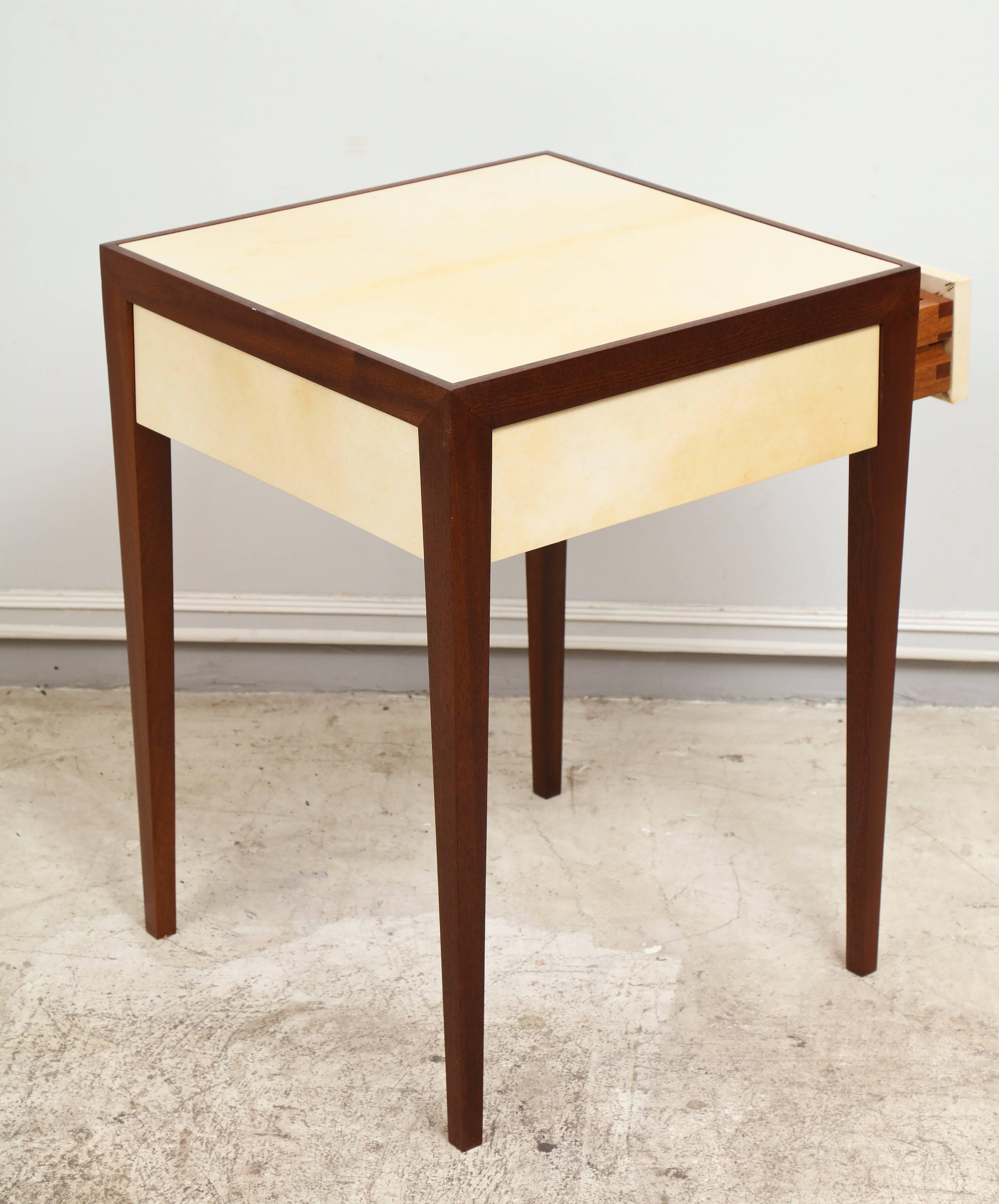 A custom mahogany end table with parchment top featuring a central drawer.
Lead Time for custom-made is 8-10 weeks.