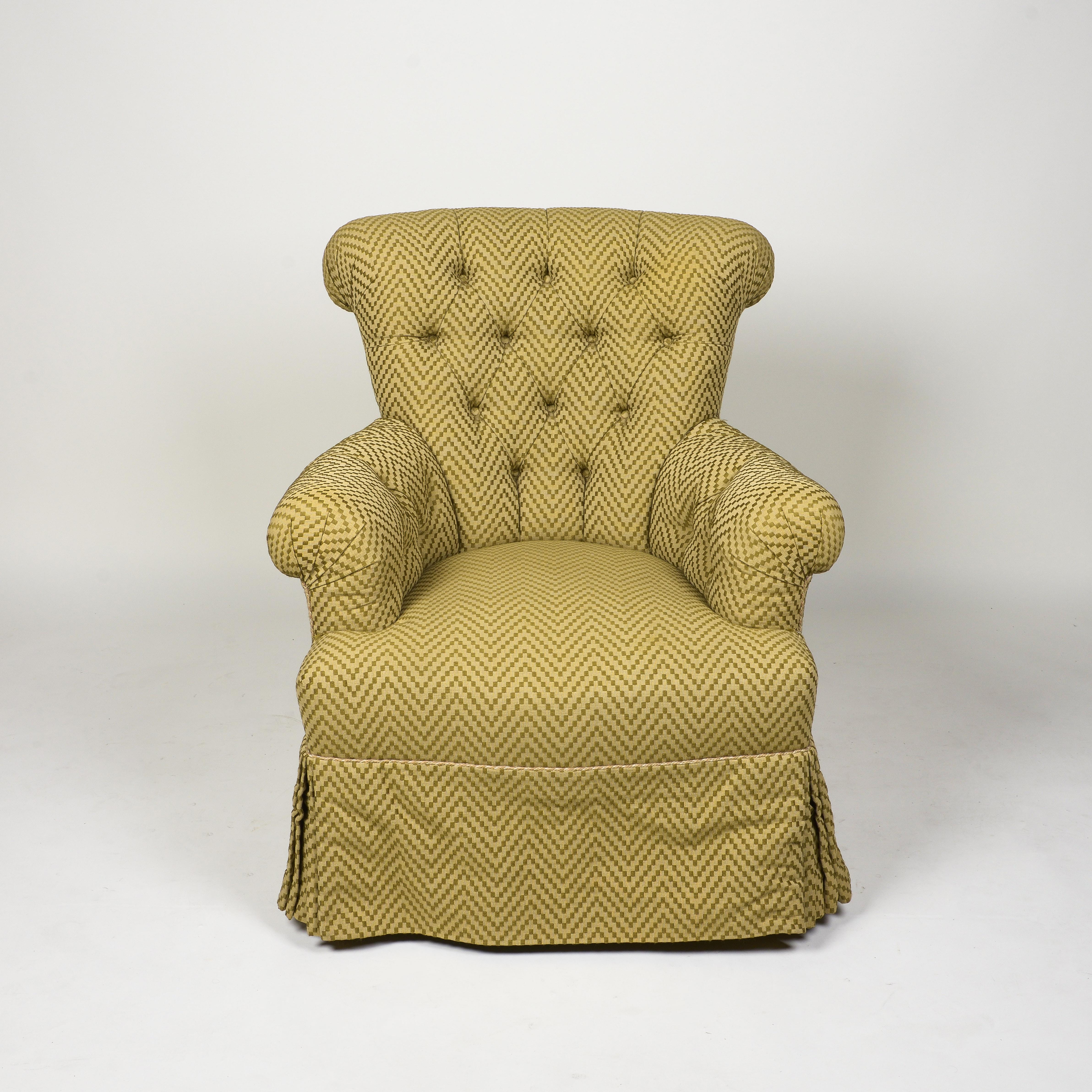 The back with outward scrolling crest, issuing low outward scrolling arms; the serpentine-fronted seat rail over a tailored skirt; upholstered in a two-toned olive green woven chevron pattern.