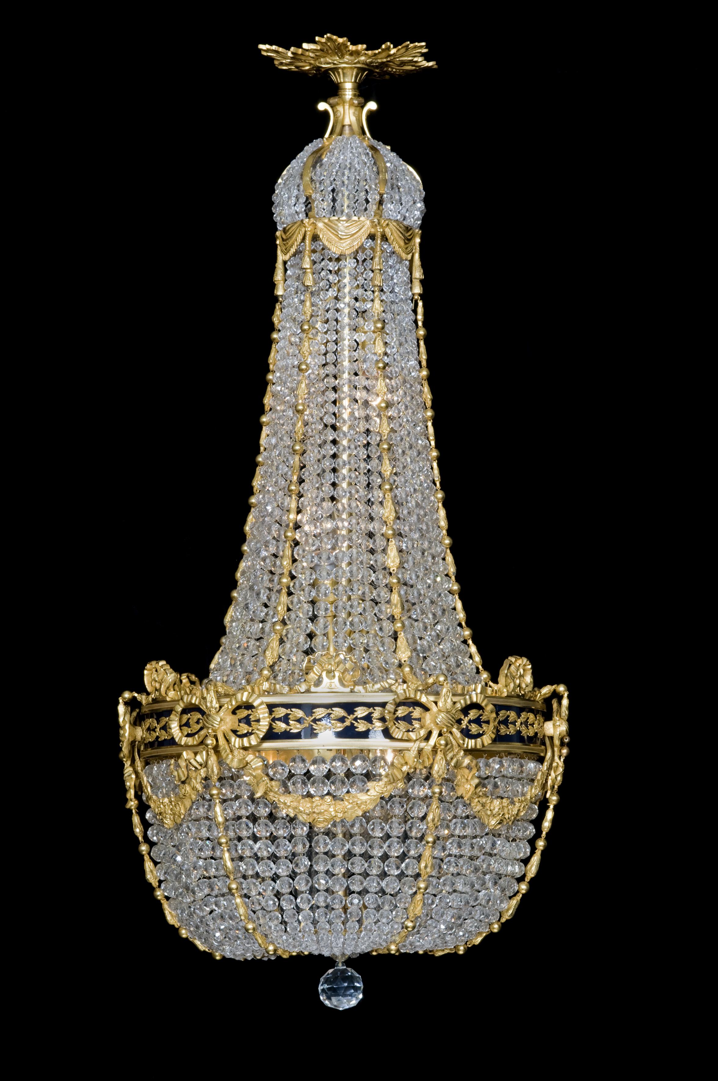 A fine gilt bronze and cut-crystal tent and bag chandelier with an enamel band.

French, circa 1880. 

This fine chandelier is of tent and bag form with wonderful gilt bronze cast foliate swags and bows and an unusual enameled central band.