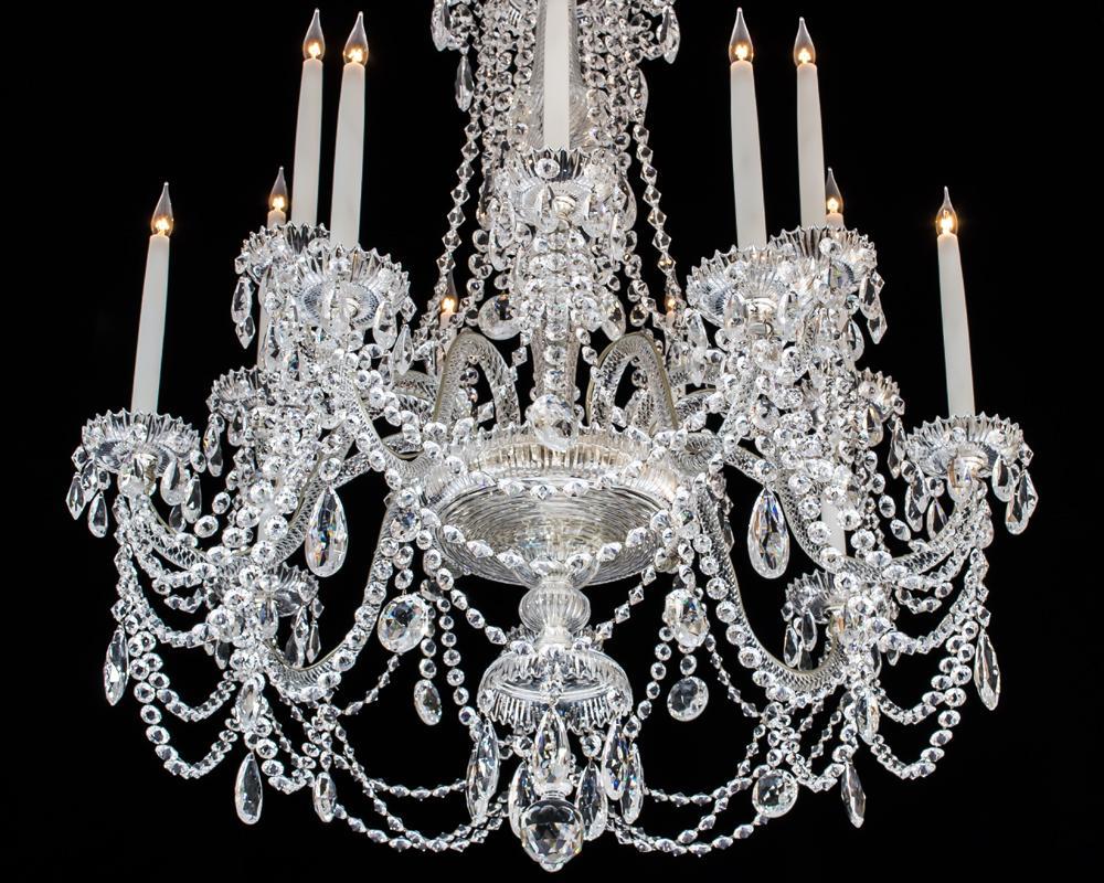 The two tiers of rope twist branches issuing from a miter cut receiver bowl this with a drop hung under canopy and lapidary cut finial, the baluster shaped shaft with draping pan and swaged canopy the chandelier profusely draped with double pointed