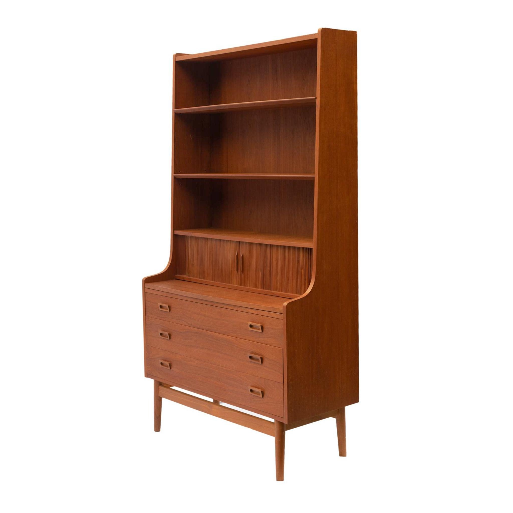 A Danish Modern Teak Secretaire bookcase designed by Johannes Sorth for Bornholm Møbelfabrik , one-part form, with three upper recessed open cabinets with beveled edge shelves over two tambour doors, with divided and fitted drawer interior, the