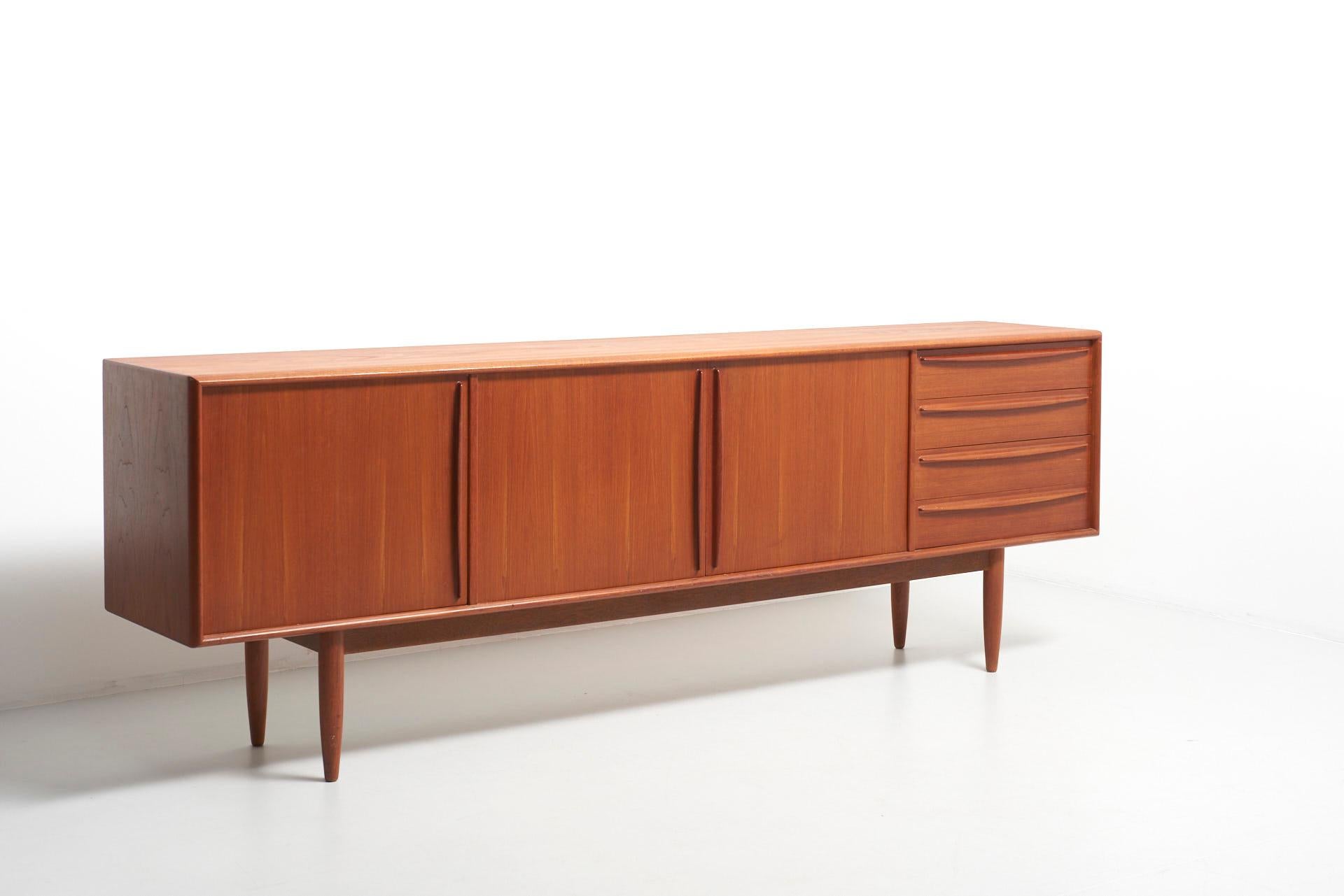 A sideboard in teak, with a bottle rack and 4 drawers. Made by HP Hansen in Denmark.