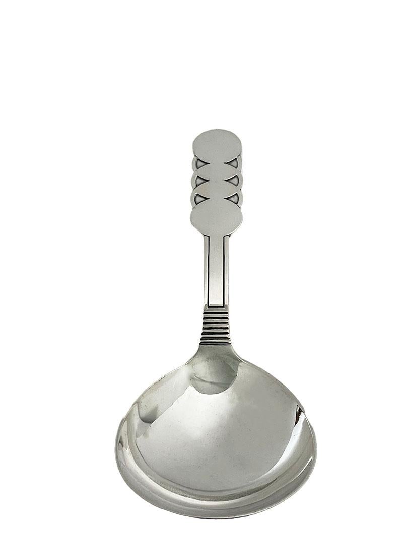 A Danish silver serving spoon, 1932

A Danish silver serving spoon with a large round bowl and round shapes on the handle. The spoon is silver hall marked by the three tower mark (Danish) and dated 1932. The Danish trademark, the master hall mark