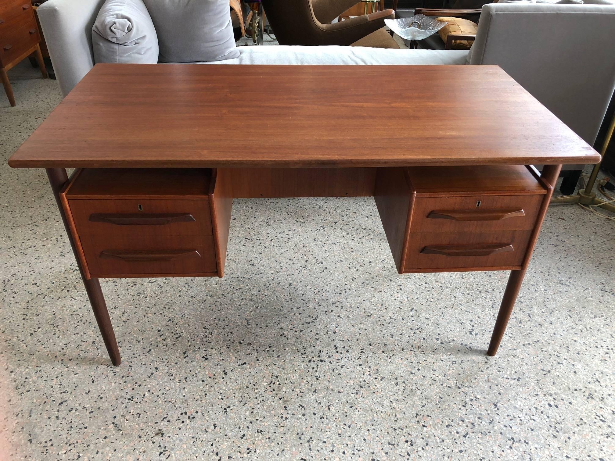 A Classic Danish midcentury desk. Floating top, teak wood, signed Pedersen. Versatile size- 26