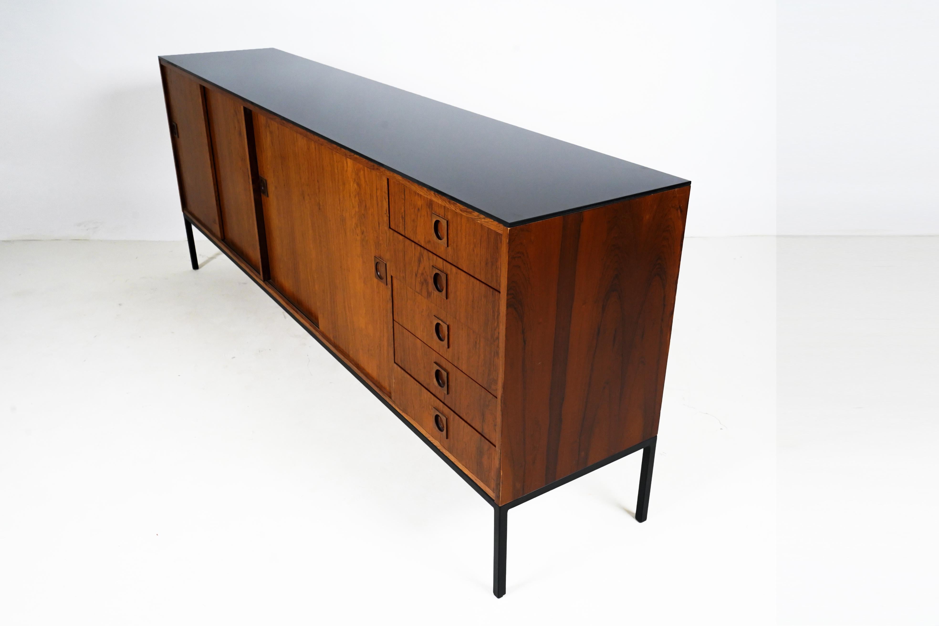This stunning sideboard is maximally Minimalist, with absolutely no decoration, aside from the beauty of the perfectly matched walnut veneers. Whereas many high-quality Scandinavian pieces of the postwar period featured exotic hardwoods such as teak