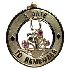  "A Date to Remember"-1950s 14 Karat Yellow Gold Charm with Pink Sapphires