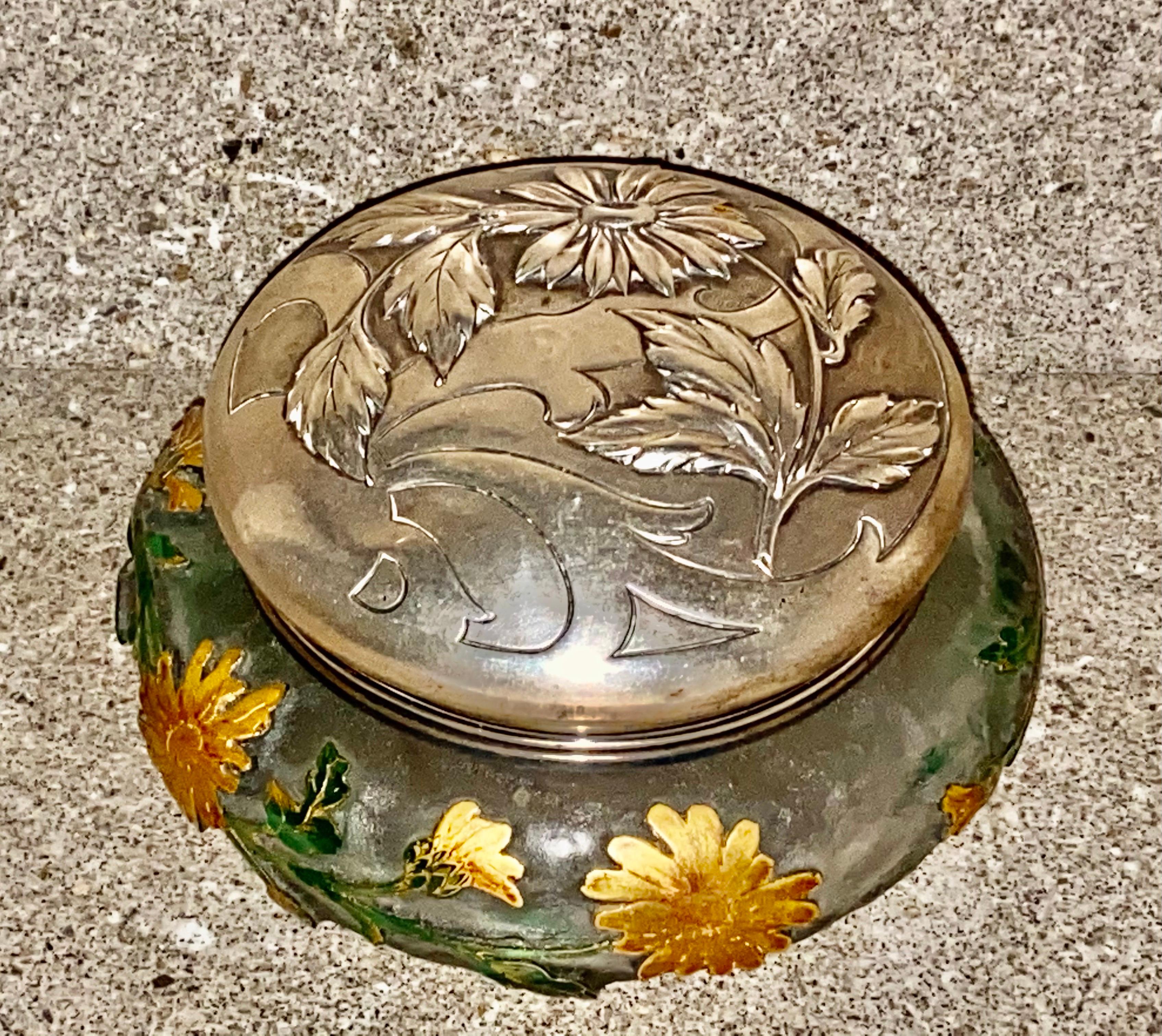The frosted bowl overlaid and acid-etched with roses, the blooms picked out in gilt, the silver cover embossed with roses and rose hips, glass signed Daum Nancy with Cross of Lorraine.