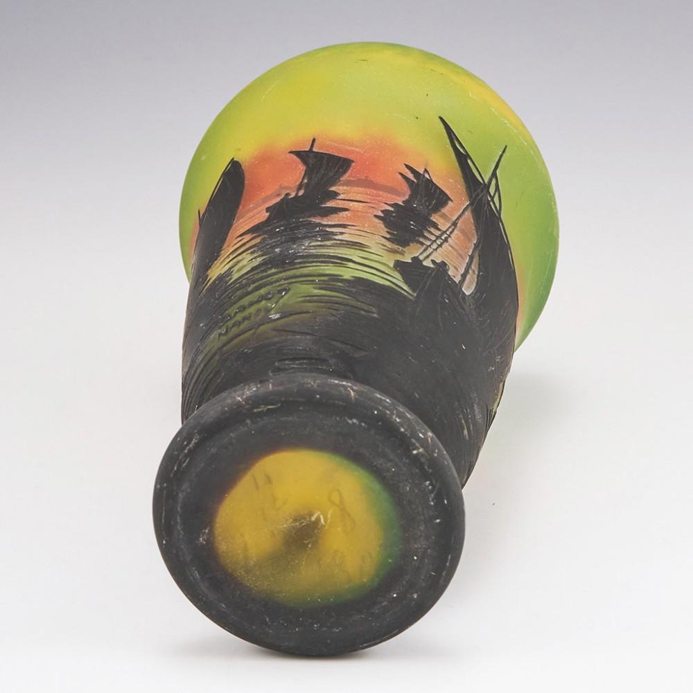 A french 1910 Daum cameo glass vase of sailboats at sunset with internal 'intercalaire' dense mottle toning from green through yellow to orange.