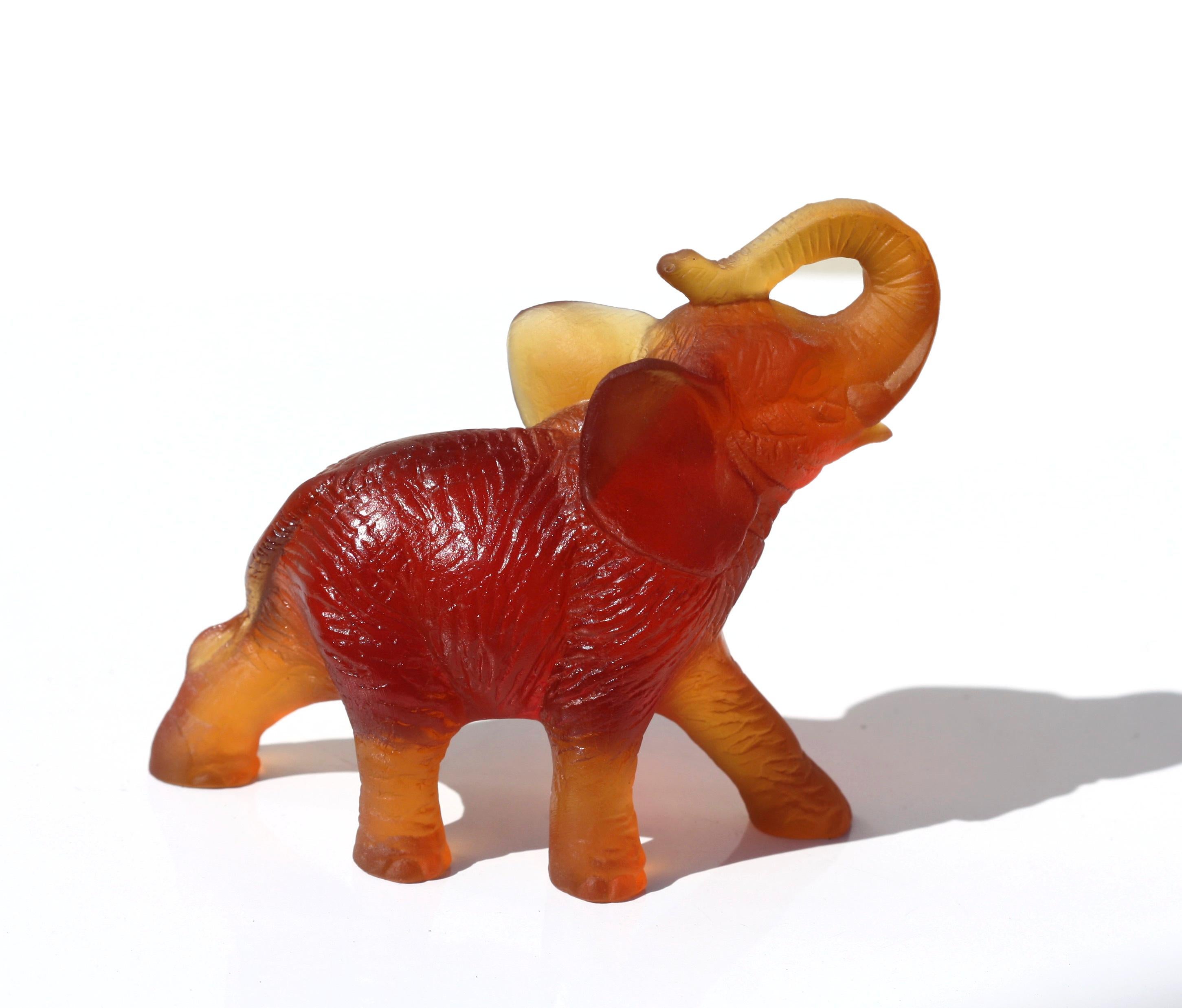 A Daum glass figure of an elephant
France, modern
in Amber Glass
engraved 'Daum France' 
signed Daum
Measures: 4 x 3 1 1/2 in.
 