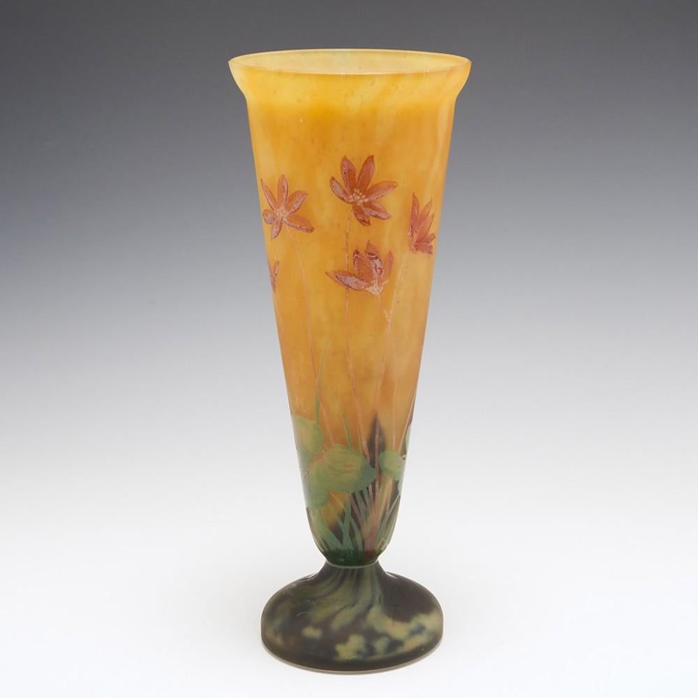 A Daum Mado Nancy Vase, c1925

Additional Information:
Heading : Mado Nancy Daum vase
Date : c1925
Period : 20th Century
Origin : The Belle Etoile, Croismare, France
Colour : Mottled orange and lemon ground enamelled in puce orange and green. The