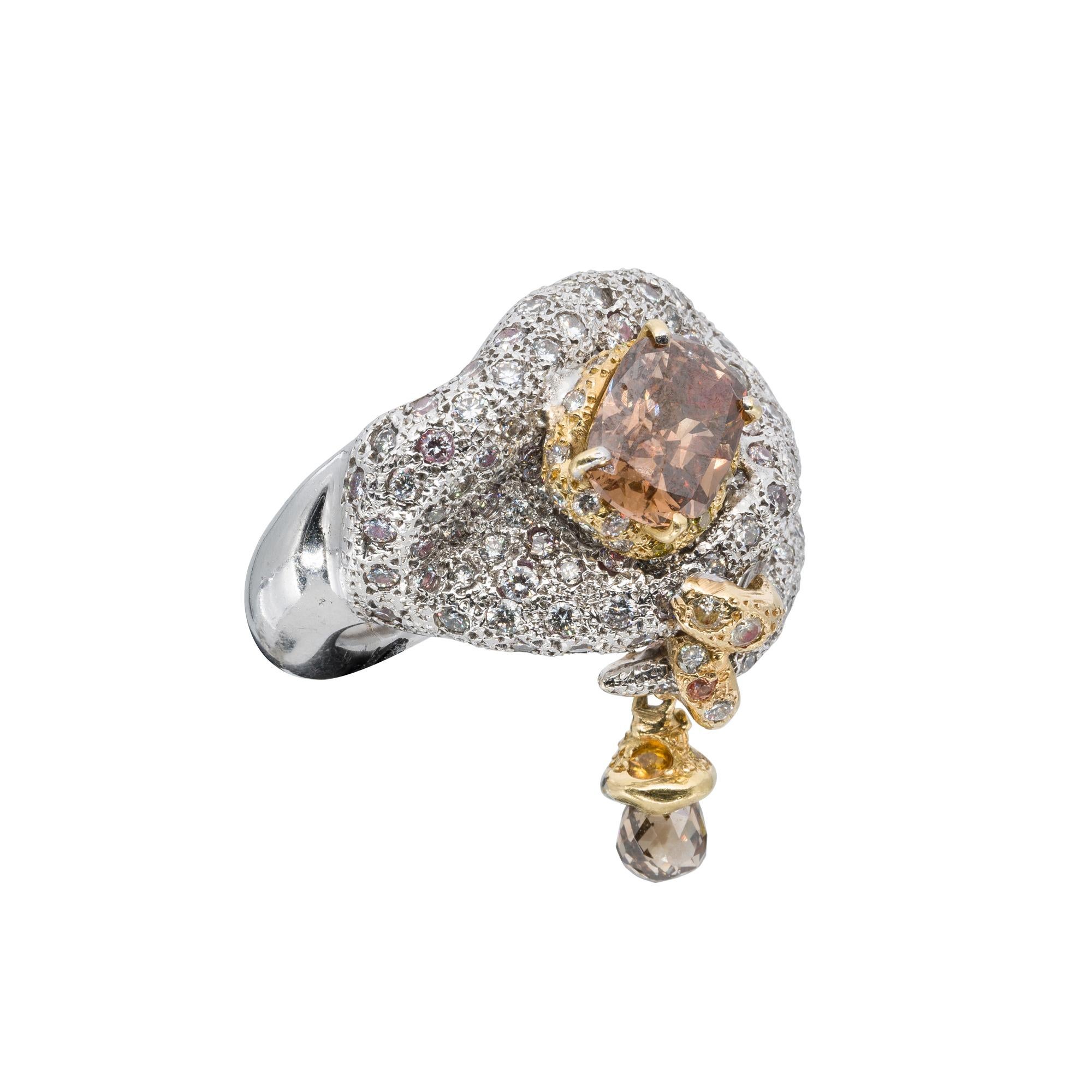 A Ring from d'Avossa Masterpiece Collection in white and yellow 18 kt gold with a Central Fancy Natural Cushion cut Cognac Diamond and a briolé pear shape diamond of the same color, dangling and giving to this Ring a touch of Movement and