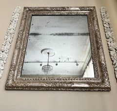 A decorative 17th Century silver gilt Lely frame as a mirror