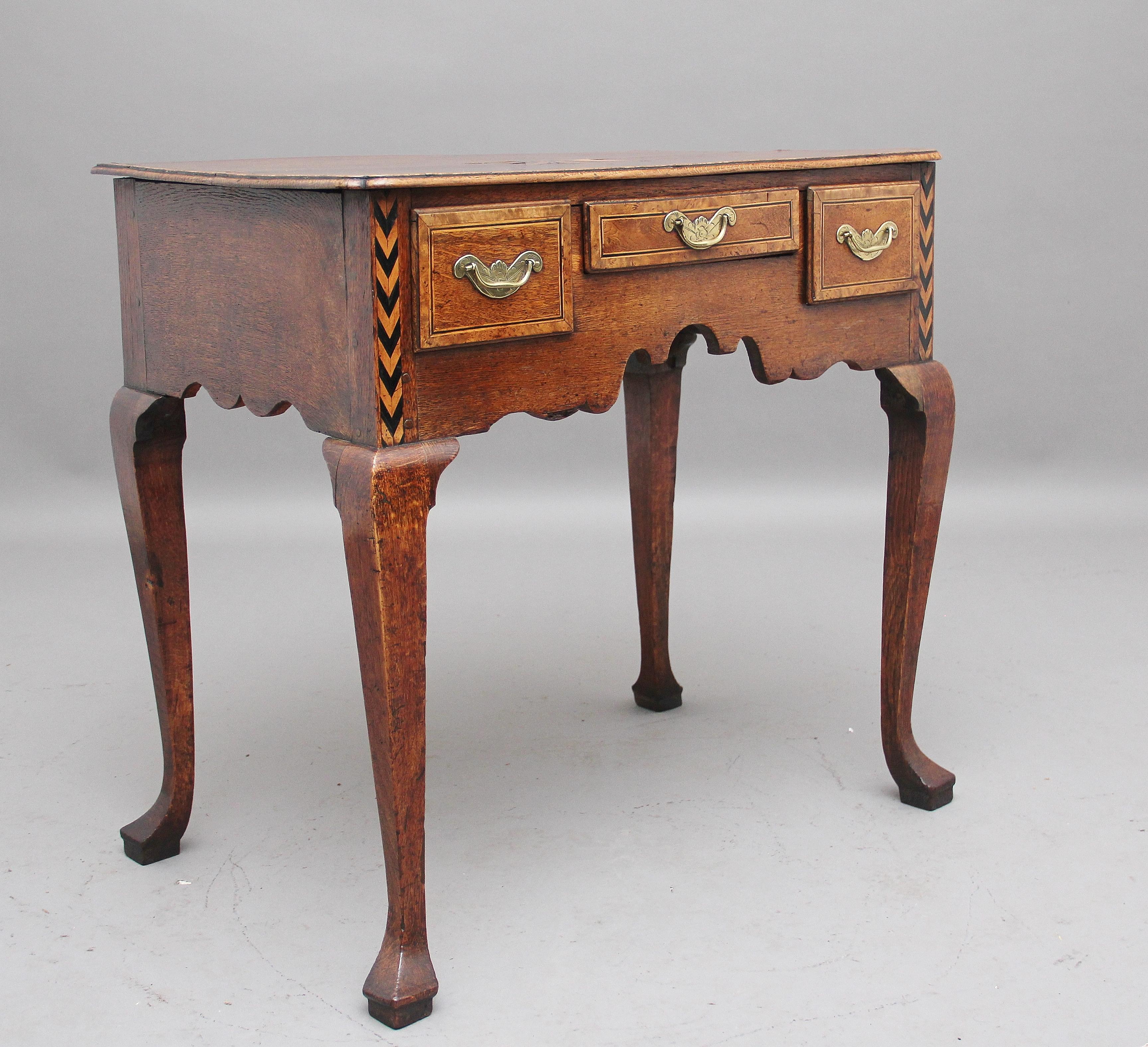A lovely quality and decorative 18th century oak lowboy, the moulded edge top having a wonderful figured top with a sunburst motif at the centre, inlay running along the edge of the top, three drawers below with original engraved brass plate