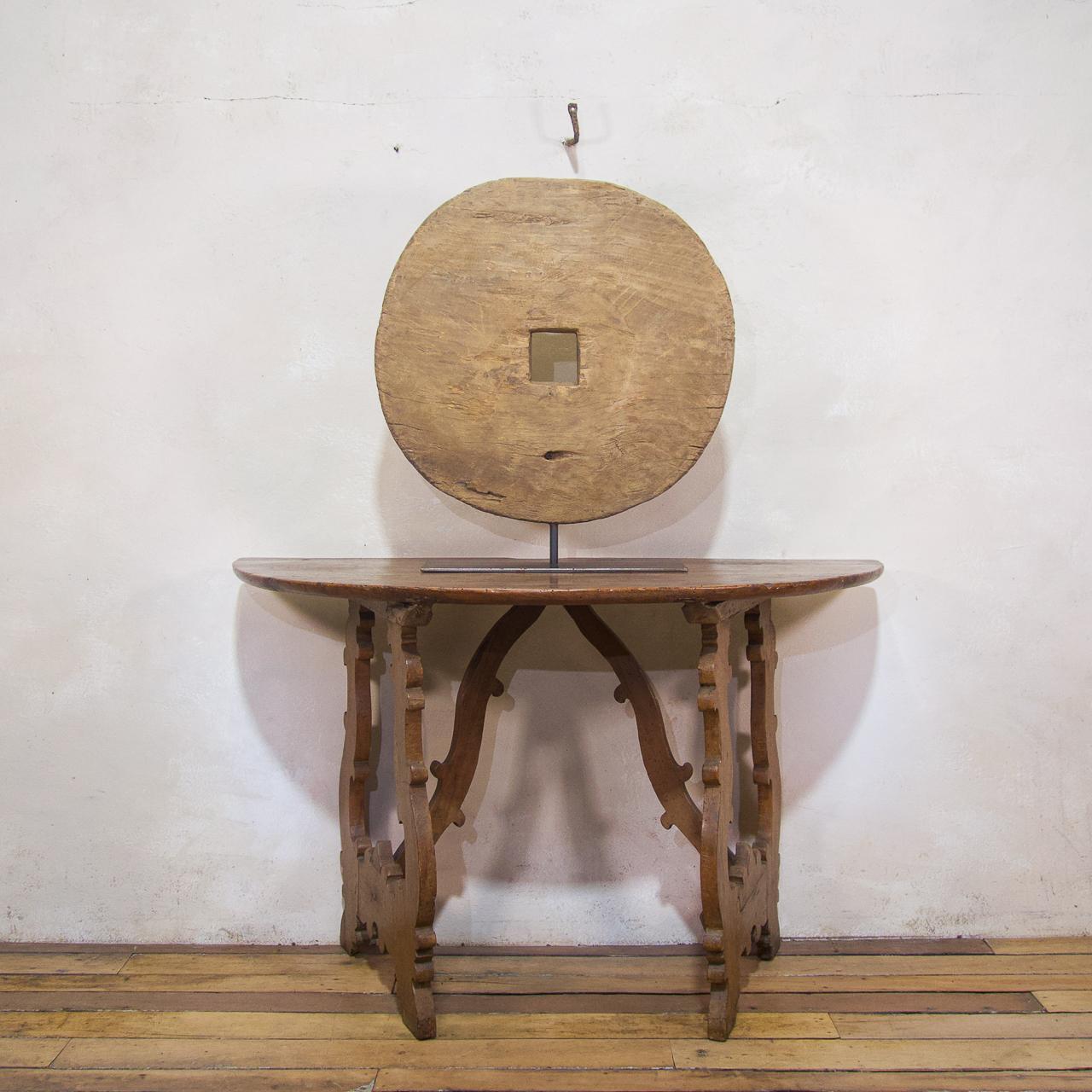 An 18th-century ox wheel mounted on a bespoke stand. Originating from Southeast Asia, A sculpture had a once functional history but now offers itself as an interesting zen-like artefact to your home or office. It has a dimensional quality where the