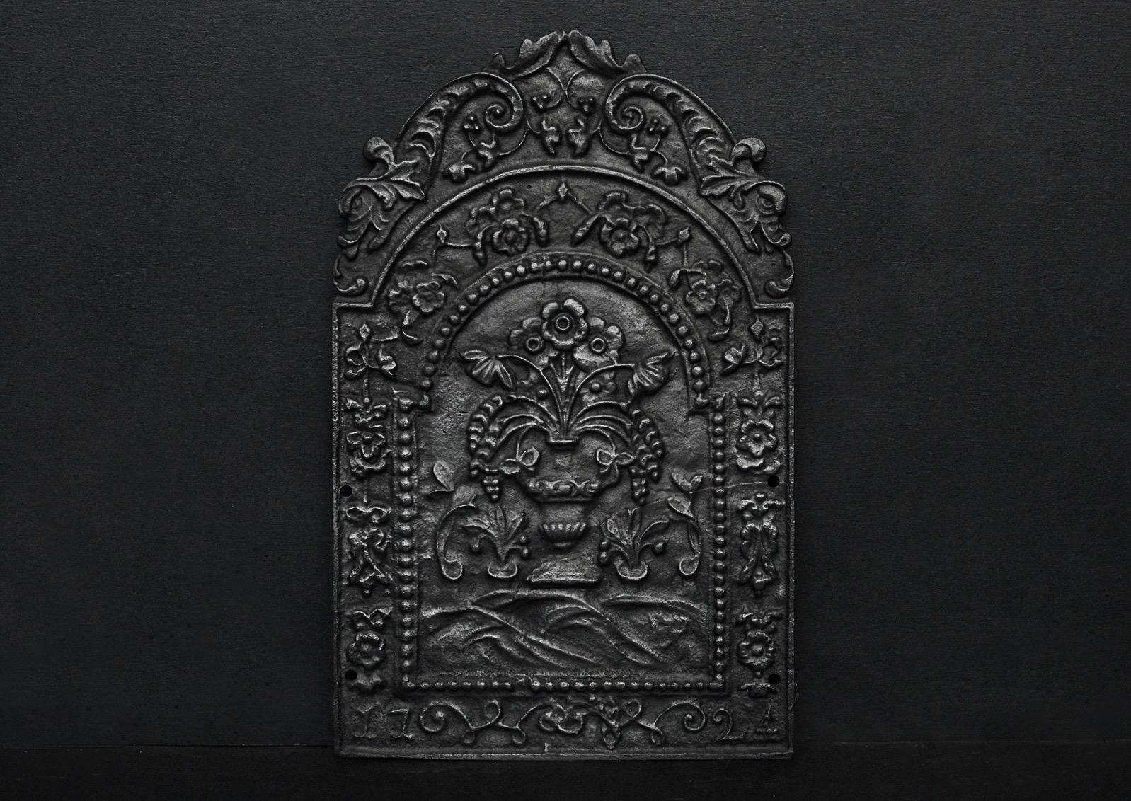 A small decorative cast iron fireback featuring scrolls and foliage. English.

Height:	617 mm      	24 ¼