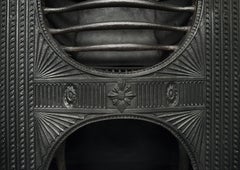 A Decorative Cast Iron Hour-Glass Hob Grate