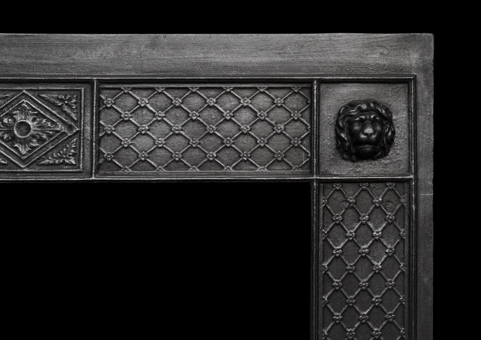 A decorative late Georgian cast iron insert. The frame with crosshatching throughout with lion masks to top. The burning area with shaped cast iron bars with guilloche fret below. English, late 18th century. Could be fully polished if