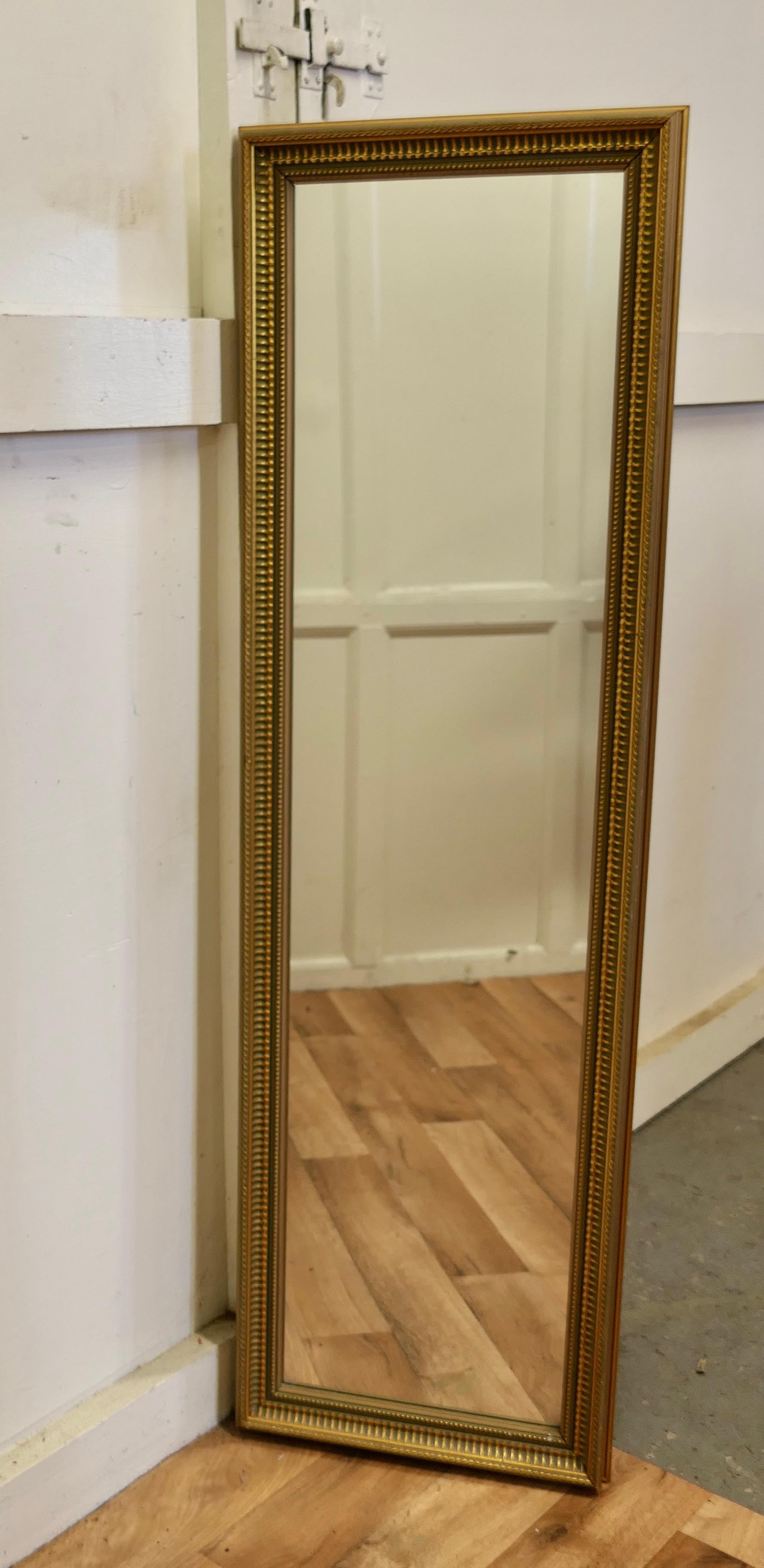A Decorative Long Gilt/Green Dressing Mirror

A delightful piece, the mirror has a 2” wide Gilt frame in gold over a green background, the glass is in good and in unblemished condition. 
A good decorative piece
The frame is 52” high and 16”