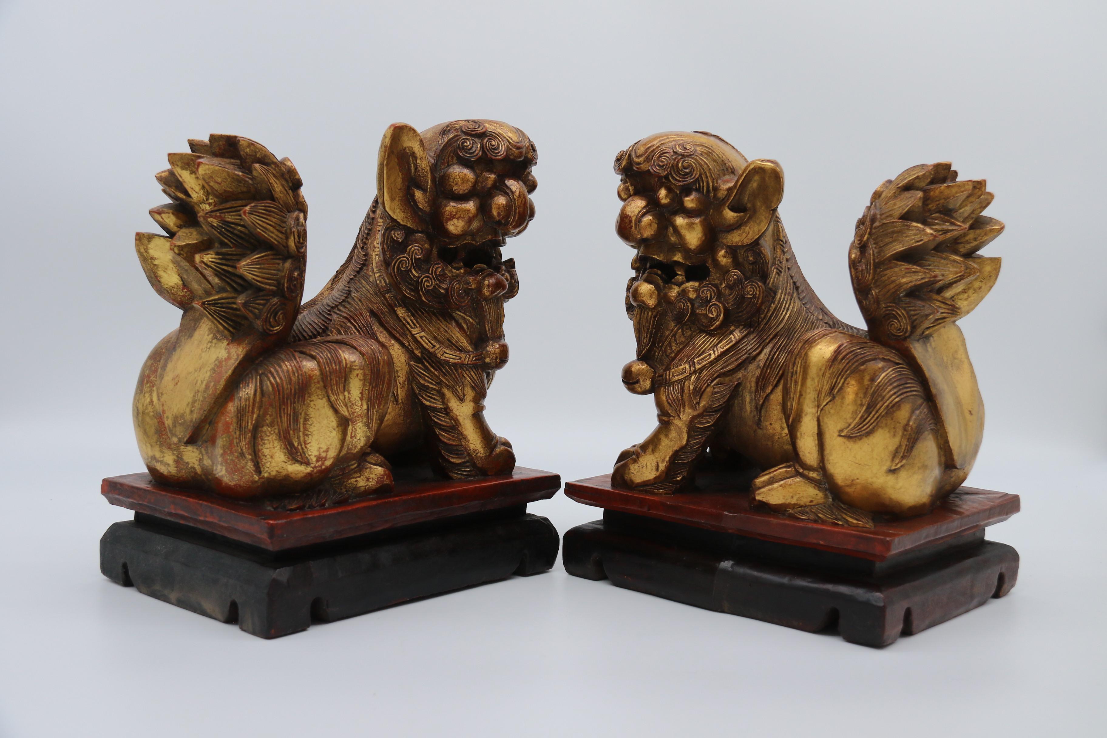 20ième siècle Paire de lions bouddhistes chinois sculptés en bois doré et laqué, vers 1900 en vente