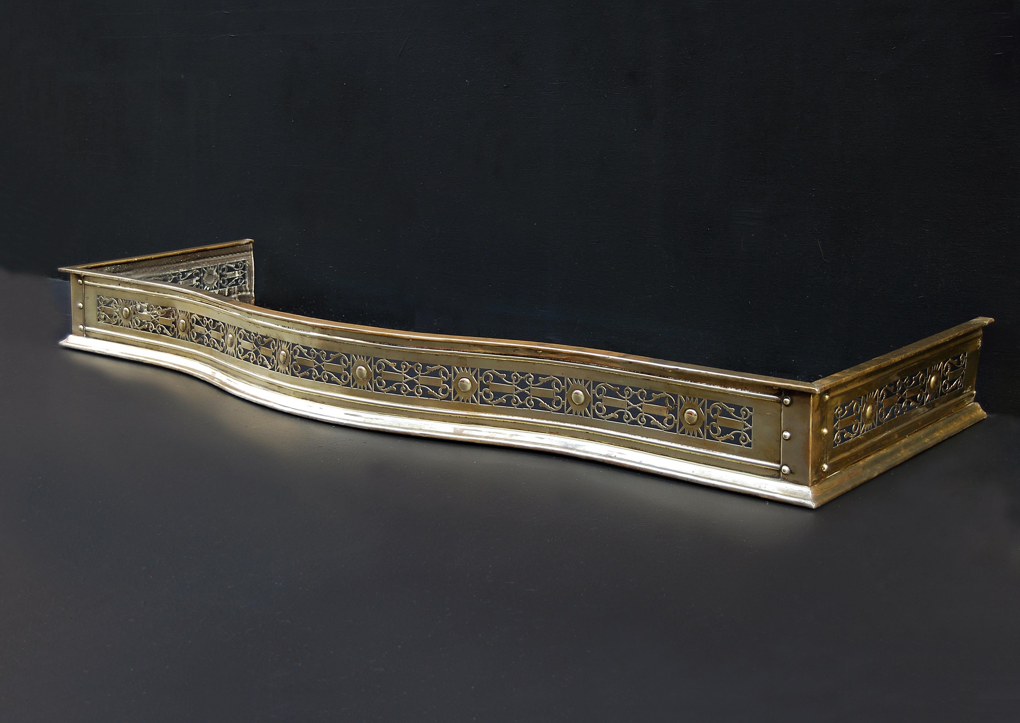 An attractive 19th century serpentine front brass fender with pierced fretwork of musical lyres. The returns with the same pierced design.

External Width:	1510 mm      	59 ½