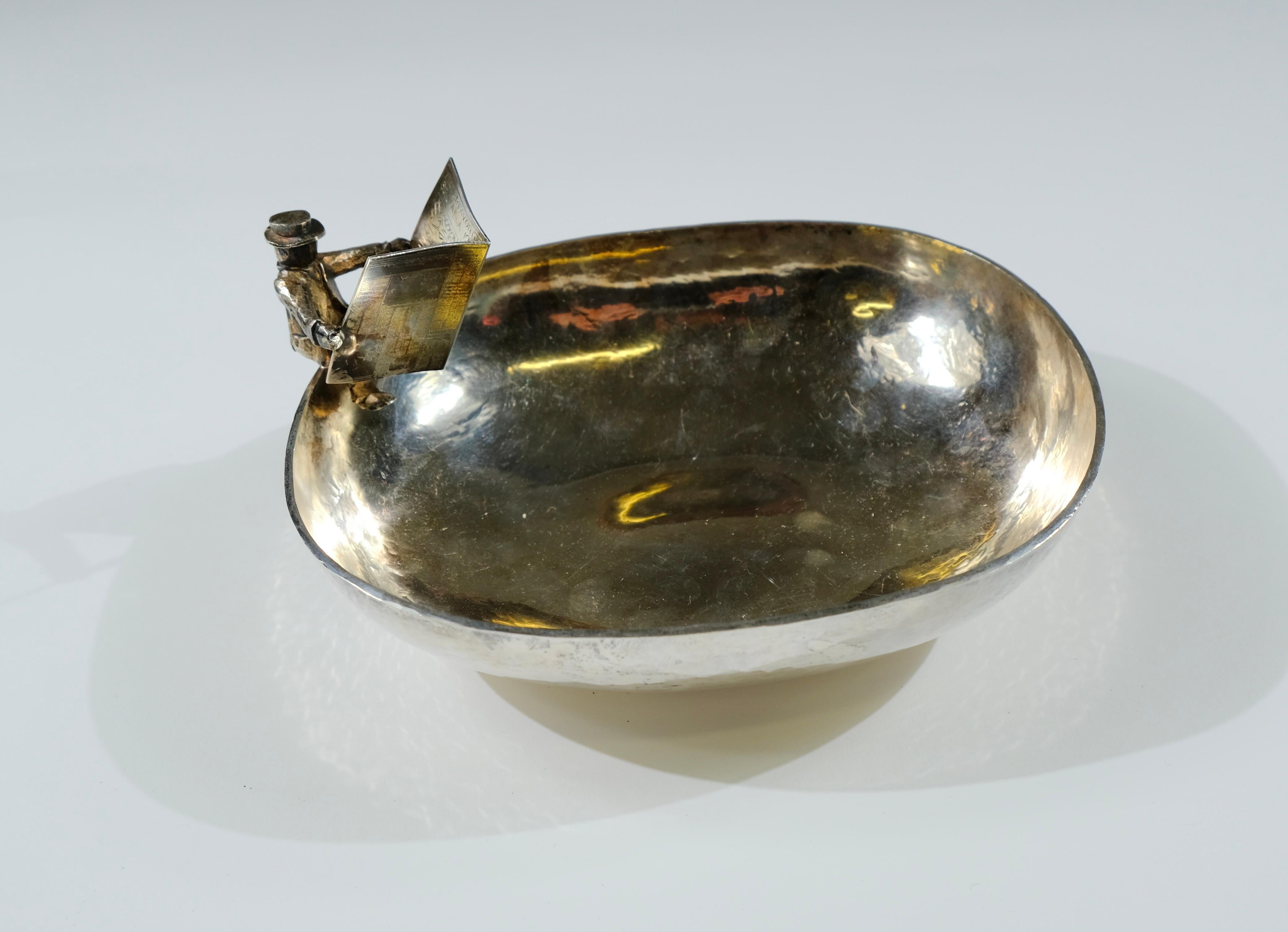 A silver-bowl made in 1982 by the Swedish silversmith Jan Lundgren. The bowl was made as a price in horse racing and has an inscription that says “Dagens Nyheters Vinterfavorit 1982”. 

The design is both interesting and funny where a man sits on