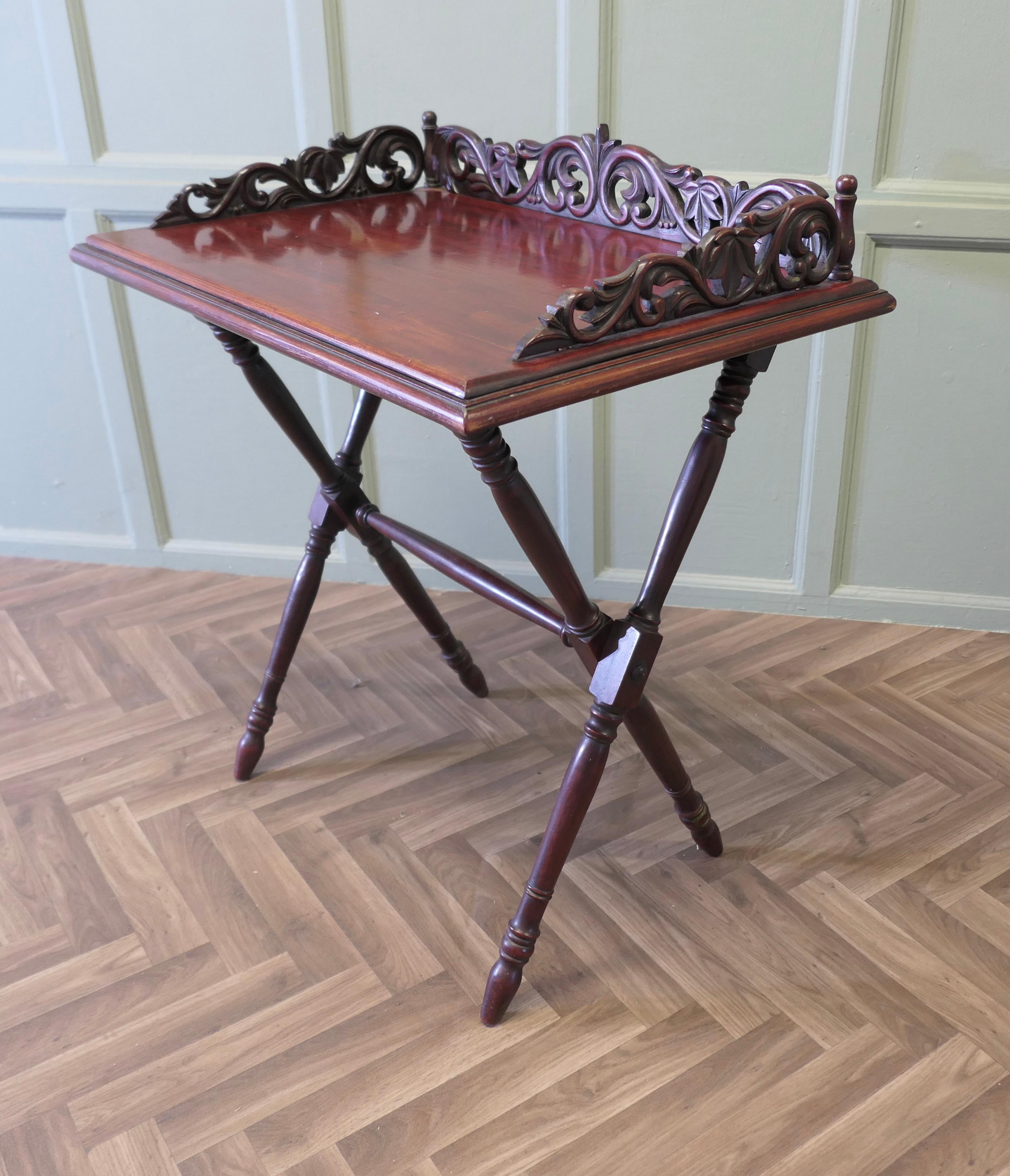 A Decoratively Carved Butlers Table, Tray on Stand
This is an attractive piece, it has a floor standing easily collapsable stand that would have been used by the butler or waiting staff when serving. The tray has a high pierced and carved gallery